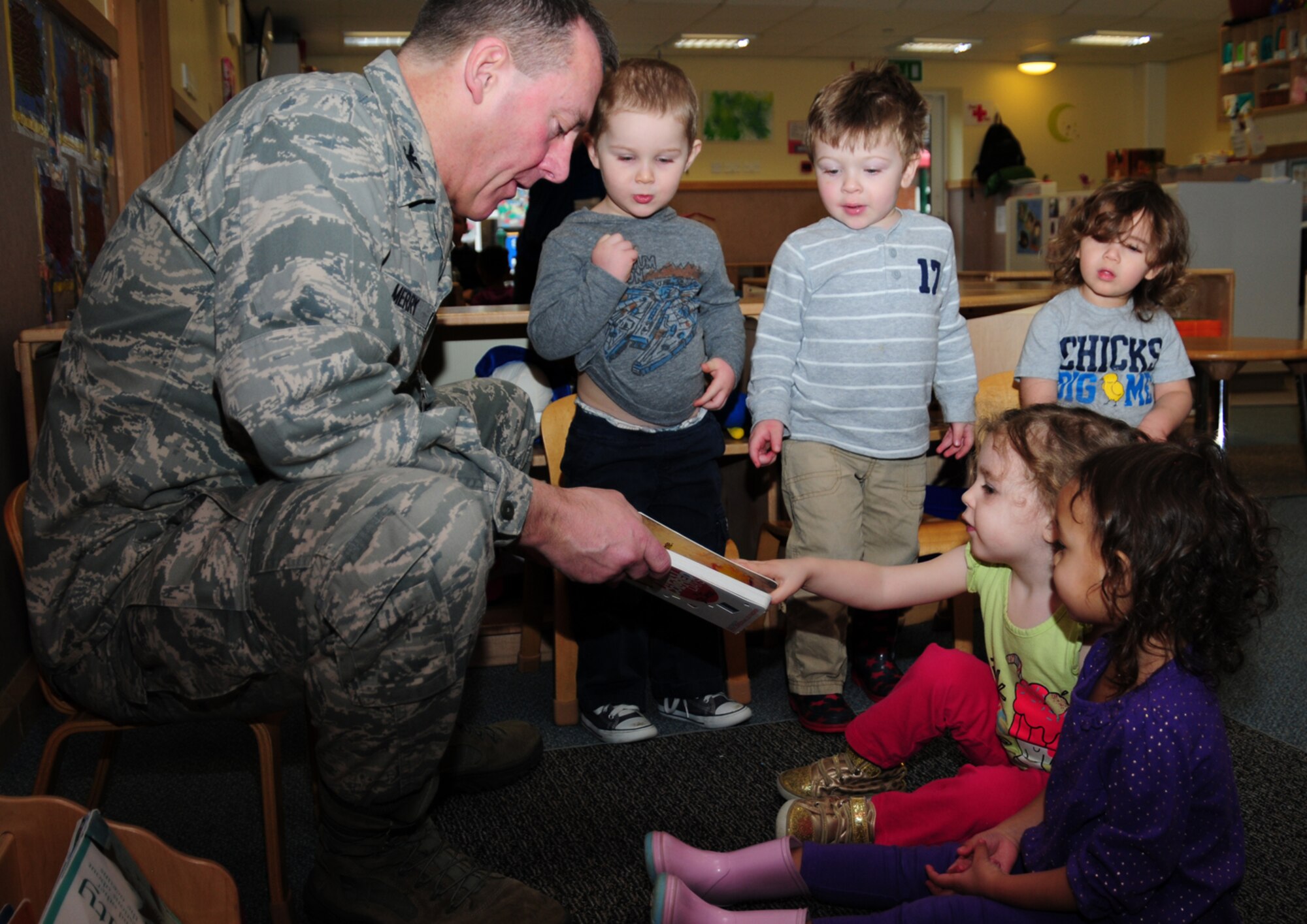 Col. Daniel Merry, 100th Mission Support Group commander, reads Dr. Seuss, “My Many Colored Days,” to children in the 2-year-old classroom March 1, 2013, at the 100th Force Support Squadron Child Development Center on RAF Mildenhall, England.  March 1 is Read Across America Day, which is a nationwide observance coinciding with the birthday of Dr. Seuss Geisel, the author of many popular children's books.  In 1997, the National Education Association pushed for a special day to celebrate reading throughout the United States. This idea proved to be a popular one; the first Read Across America Day was held March 2, 1998. (U.S. Air Force photo by Karen Abeyasekere/Released)