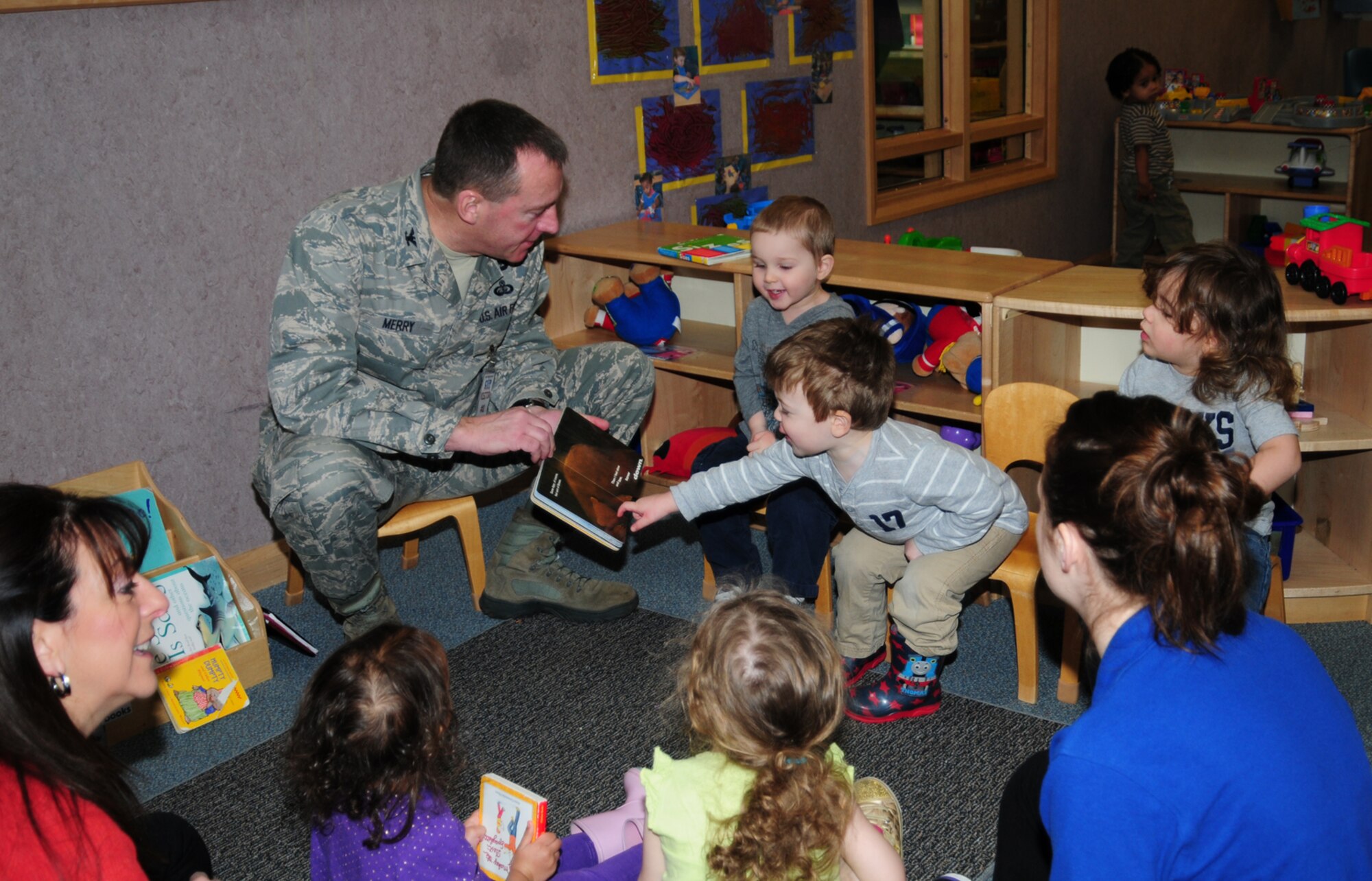 Col. Daniel Merry, 100th Mission Support Group commander, reads Dr. Seuss, “My Many Colored Days,” to children in the 2-year-old classroom March 1, 2013, at the 100th Force Support Squadron Child Development Center on RAF Mildenhall, England.  March 1 is Read Across America Day, which is a nationwide observance coinciding with the birthday of Dr. Seuss Geisel, the author of many popular children's books.  In 1997, the National Education Association pushed for a special day to celebrate reading throughout the United States. This idea proved to be a popular one; the first Read Across America Day was held March 2, 1998. (U.S. Air Force photo by Karen Abeyasekere/Released)