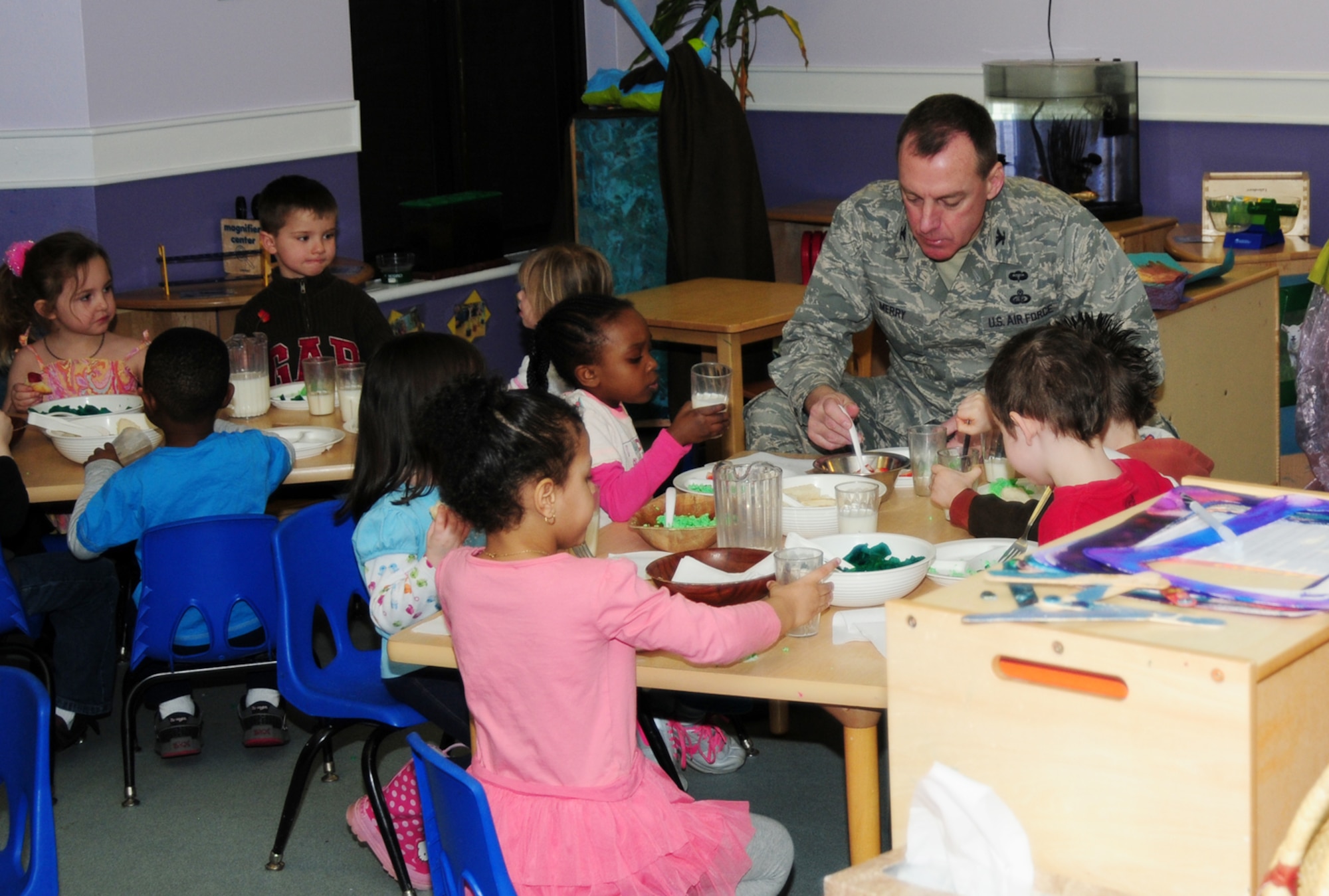Col. Daniel Merry, 100th Mission Support Group commander, shares a green eggs and ham breakfast with children from a pre-school class March 1, 2013, at the 100th Force Support Squadron Child Development Center on RAF Mildenhall, England.  March 1 is Read Across America Day, which is a nationwide observance coinciding with the birthday of Dr. Seuss Geisel, the author of many popular children's books.  In 1997, the National Education Association pushed for a special day to celebrate reading throughout the United States. This idea proved to be a popular one; the first Read Across America Day was held March 2, 1998. (U.S. Air Force photo by Karen Abeyasekere/Released)
