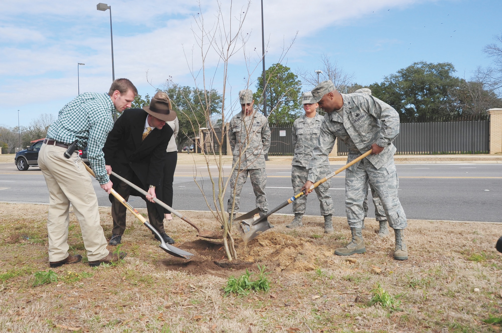 Colonel Trent Edwards, 42nd Air Base Wing commander, right, plants a tree at Thunderbird Park with Matt McCullough, Alabama Forestry Commission, and Russell Stringer, city urban forester, marking the 20th anniversary of Maxwell's Arbor Day celebration. The crepe myrtle commemorates Maxwell's designation as a Tree City USA community. (U.S. Air Force photo by Staff Sgt. Sandra Percival)
