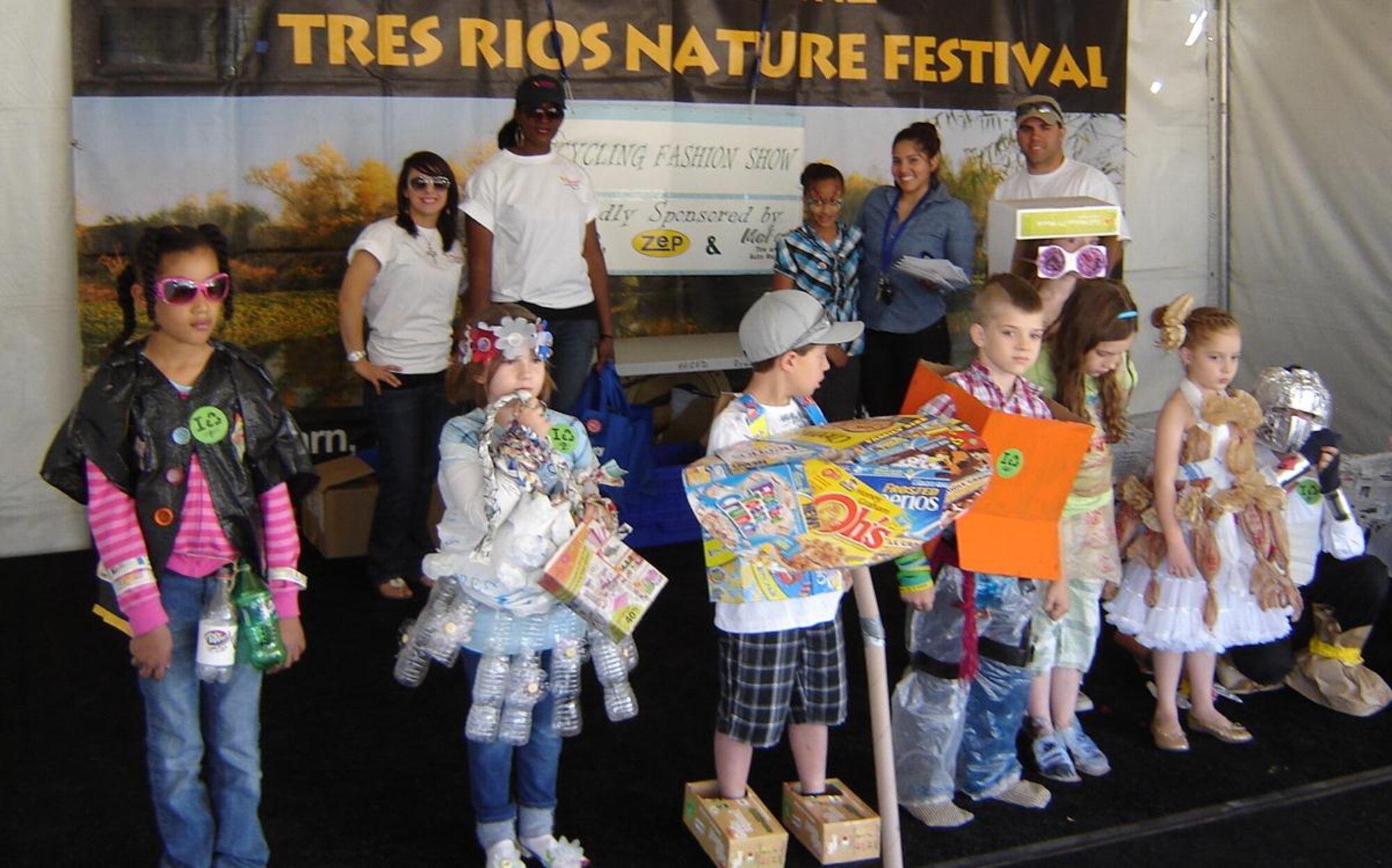 Children participate in the 2012 Tres Rios Nature and Earth Festival recycling fashion show alongside Luke’s fashion show coordinators Oct. 12, 2012, at the Base and Meridian Wildlife Area in Avondale, Ariz. The festival focuses on educating participants about the Gila, Salt and Agua Fria rivers as well as the surrounding wildlife.  (Courtesy photo)
