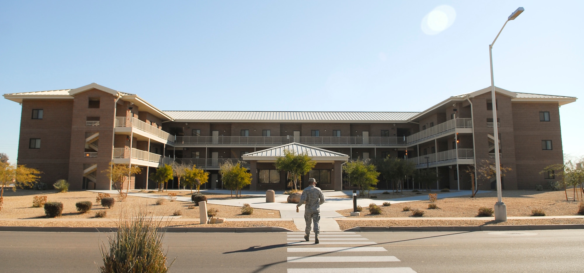 An Airman walks to Bldg. 586 Feb. 14 on Luke Air Force Base. Bldg. 586 is one of ten dorms occupied by Airmen at Luke. (U.S. Air Force photo/Airman 1st Class Grace Lee)