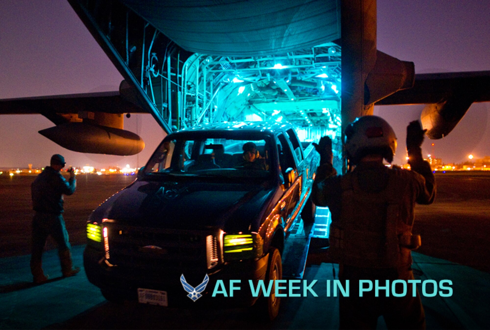 Senior Airman Noel Jones marshals a vehicle off a C-130 Hercules cargo aircraft during a night operations exercise Feb. 26, 2013, at Yokota Air Base, Japan. As part of readiness week, C-130 aircrews tested their airlift capabilities in a series of practice missions. Noel is a 36th Airlift Squadron loadmaster. (U.S. Air Force photo/Staff Sgt. Chad C. Strohmeyer)