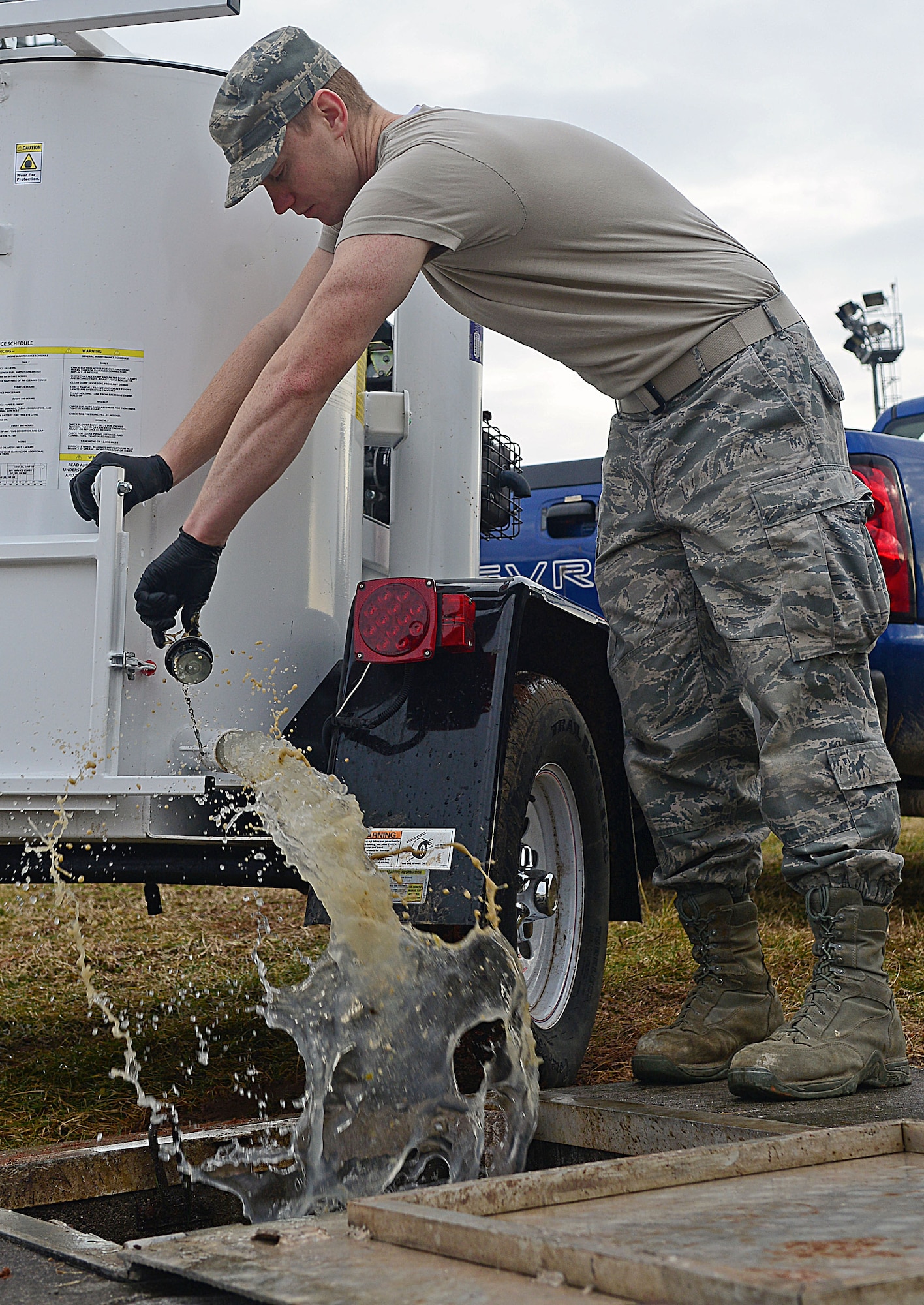 Senior Airman Benjamin Krage, 31st Civil Engineer Squadron water and fuel systems maintenance journeyman, empties waste into a water hole Feb. 14, 2013, at Aviano Air Base, Italy. Once a week, at least two crew members provide upkeep on the septic tanks or grease traps that need to be emptied. (U.S. Air Force photo/Airman 1st Class Matthew Lotz)