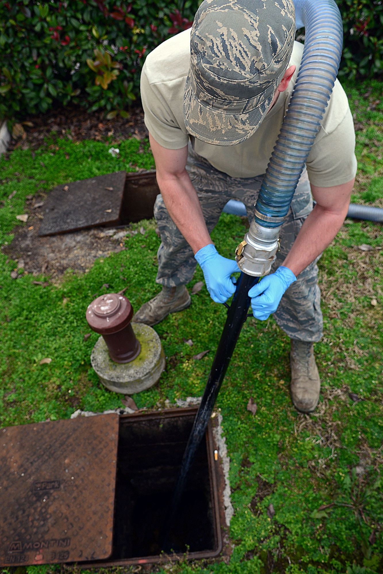 Airman 1st Class David Krenning, 31st Civil Engineer Squadron water and fuel systems maintenance journeyman, vacuums waste from a grease trap using the Trav-L-Vac 300 Feb. 14, 2013, at Aviano Air Base, Italy. Krenning is also in charge of water distribution and fire suppression/fuel systems for the firefighters. (U.S. Air Force photo/Airman 1st Class Matthew Lotz)