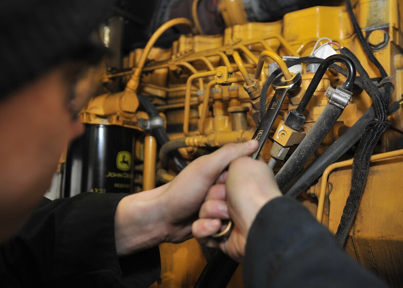 Airman 1st Class Jacob Ward, 100th Logistics Readiness Squadron special purpose vehicle mechanic from Roseburg, Ore., bleeds the fuel line of a Front End Loader Feb. 28, 2013, at RAF Mildenhall, England. The vehicle management flight maintains special purpose vehicles such as bobtails, forklifts and rollback wrecker tow trucks. (U.S. Air Force photo by Senior Airman Jerilyn Quintanilla/Released)