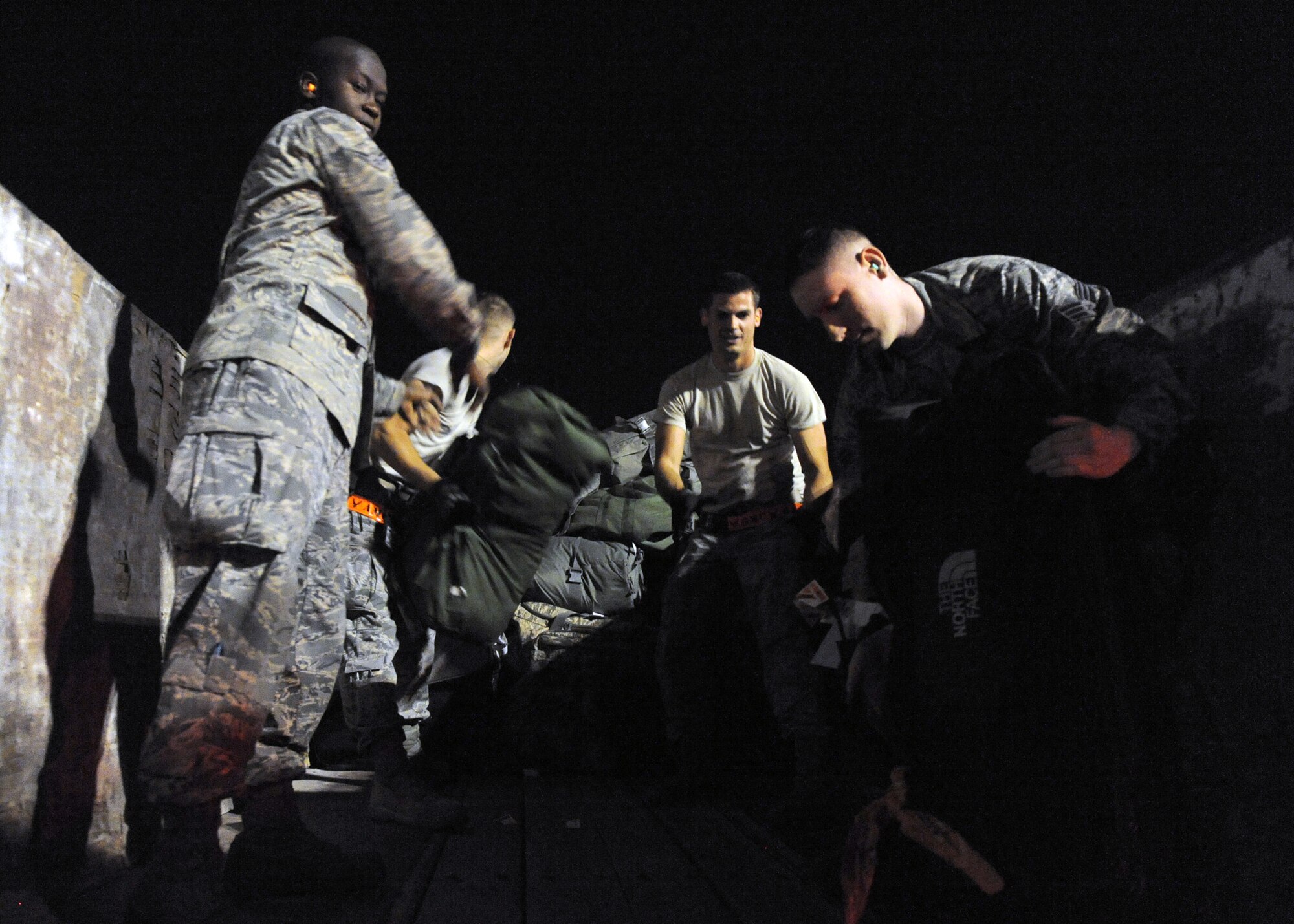 SOUTHWEST ASIA – Volunteer baggage detail along with 8th Expeditionary Air Mobility Squadron Airmen, load luggage to be delivered to service members waiting at host nation immigrations Feb. 27. For luggage going back stateside 8th EAMS Airmen also perform Transportation Security Administration passenger and baggage screening to the same standard as commercial airports in the United States. The squadron processed more than 3,500 tons of baggage in the past year. (U.S. Air Force photo/Senior Airman Joel Mease)