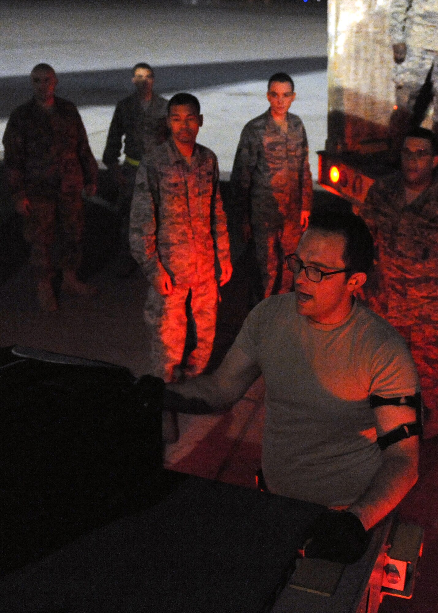 SOUTHWEST ASIA - Airman 1st Class Daniel Hodge, 8th Expeditionary Air Mobility Squadron, directs luggage to a team of volunteers, who recently arrived at the 379th Air Expeditionary Wing Feb. 27. Because of the large amount of luggage and passengers, 8th EAMS Airmen safely but quickly download all luggage, so service members can get through host nation immigrations in a timely manner. The squadron strives to provide first-class customer service for all passengers from the youngest service member on his or her first deployment to distinguished visitors, who visit the 379th AEW. Hodge is deployed from the 721st Aerial Port Squadron at Ramstein Air Base, Germany. (U.S. Air Force photo/Senior Airman Joel Mease)