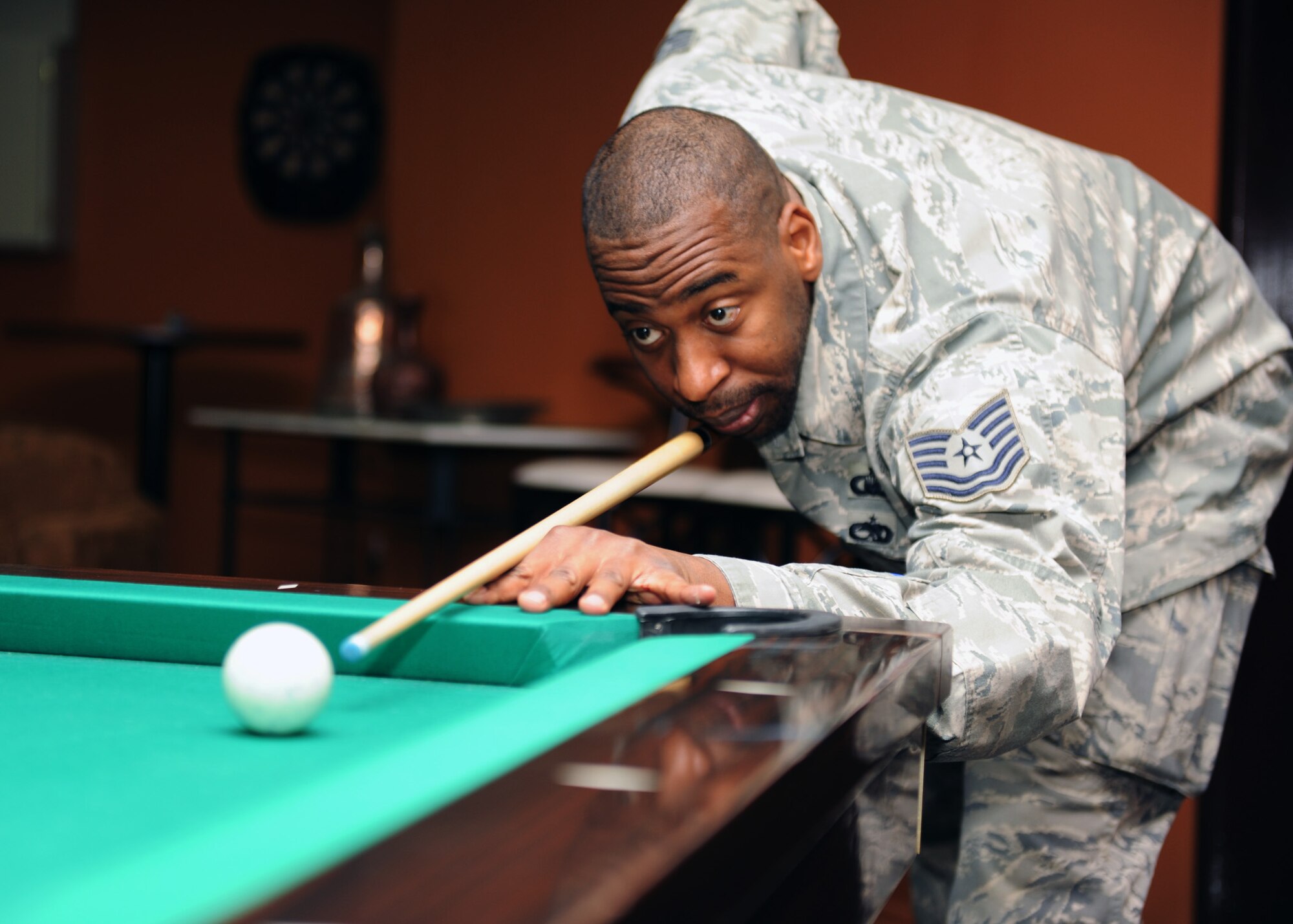 Tech. Sgt. John Geer, 39th Air Base Wing chaplains assistant, plays pool on the new table at The Connections grand reopening Feb. 27, 2013, at Incirlik Air Base, Turkey. The Connections is a Chapel-run facility that features Wi-Fi, snacks, a pool table, couches, a TV and more available for members of the Incirlik community. (U.S. Air Force photo by Staff Sgt. Marissa Tucker/Released)