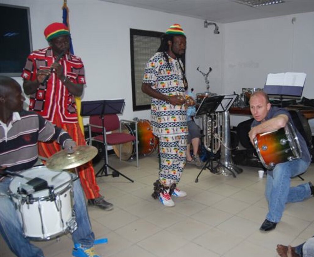 Master Sgt. Steve Przyzcki, a percussionist for the Wings of Dixie ensemble of the United States Air Forces in Europe-Air Forces Africa Band, kneels down and plays a tom tom drum from his knee during a music workshop at the U.S. Embassy in N’Djamena, Chad Feb. 23, 2013. The workshop was attended by nearly 40 Chadian musicians and was part of the Band’s weeklong visit to the African nation. U.S. Air Force Courtesy Photo