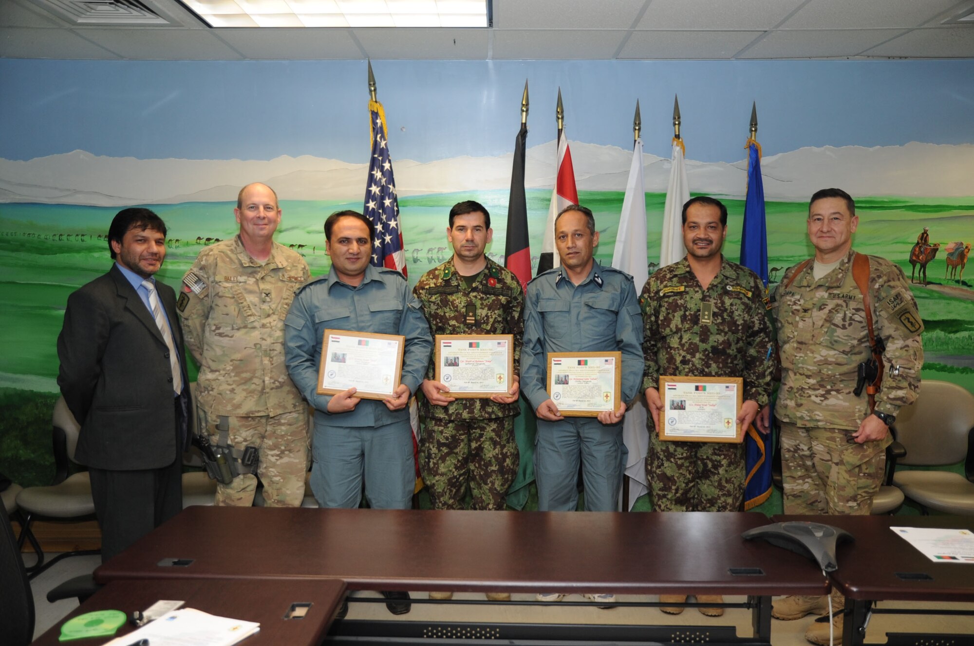 The graduates of the February Afghan Trauma Mentorship Program class display their certificates at the Craig Joint Theater Hospital on Bagram Airfield, Afghanistan, Feb. 28, 2013. The four surgeons from the Afghan National Army and Police spent three weeks at the CJTH learning about the latest medical equipment and techniques. (U.S. Air Force photo/Staff Sgt. David Dobrydney)