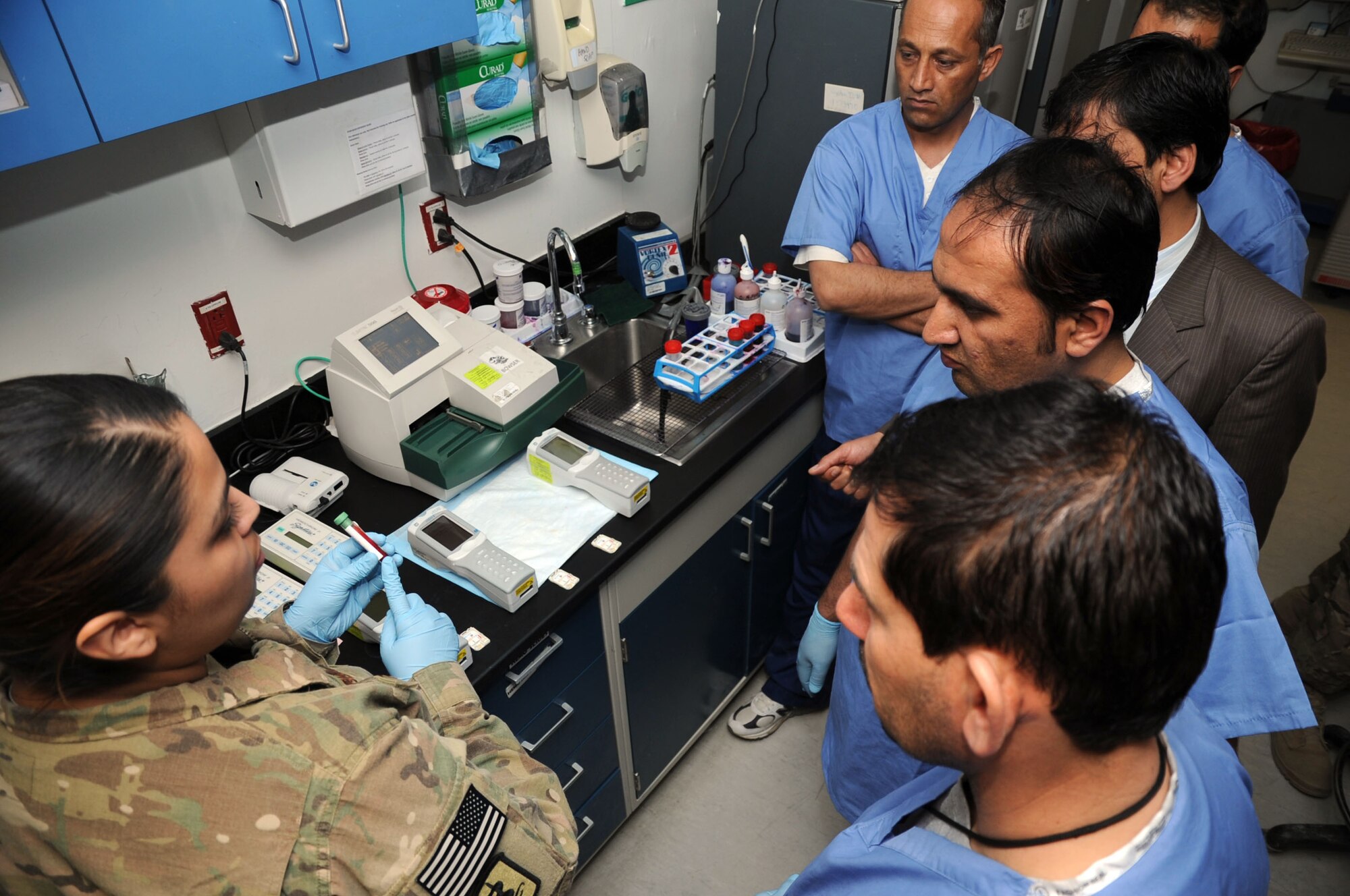 Senior Airman Krystal Rodriguez, 455th Expeditionary Medical Support Squadron medical lab technician, gives members of the Afghan Trauma Mentorship Program a tour of the Craig Joint Theater Hospital laboratory on Bagram Airfield, Afghanistan, Feb. 16, 2013. The Afghan doctors spent a month at the CJTH learning about the latest medical equipment and techniques. (U.S. Air Force photo/Staff Sgt. David Dobrydney)
