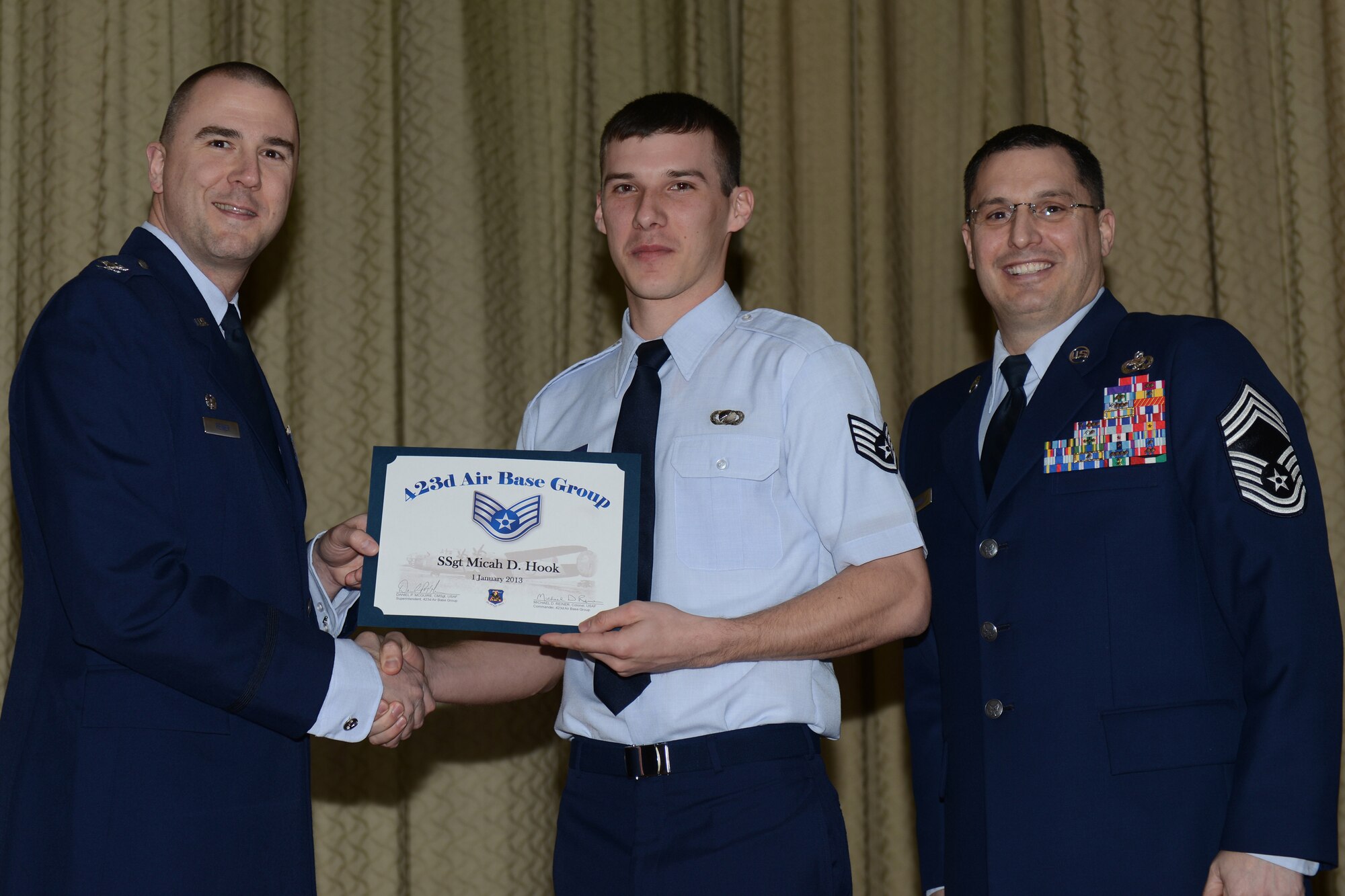 RAF ALCONBURY, United Kingdom – Staff Sgt. Micah Hook, 501st Combat Support Wing, receives his certificate for promotion to staff sergeant Feb. 28 at the RAF Alconbury Theater. (U.S. Air Force photo by Tech. Sgt. Chrissy Best)