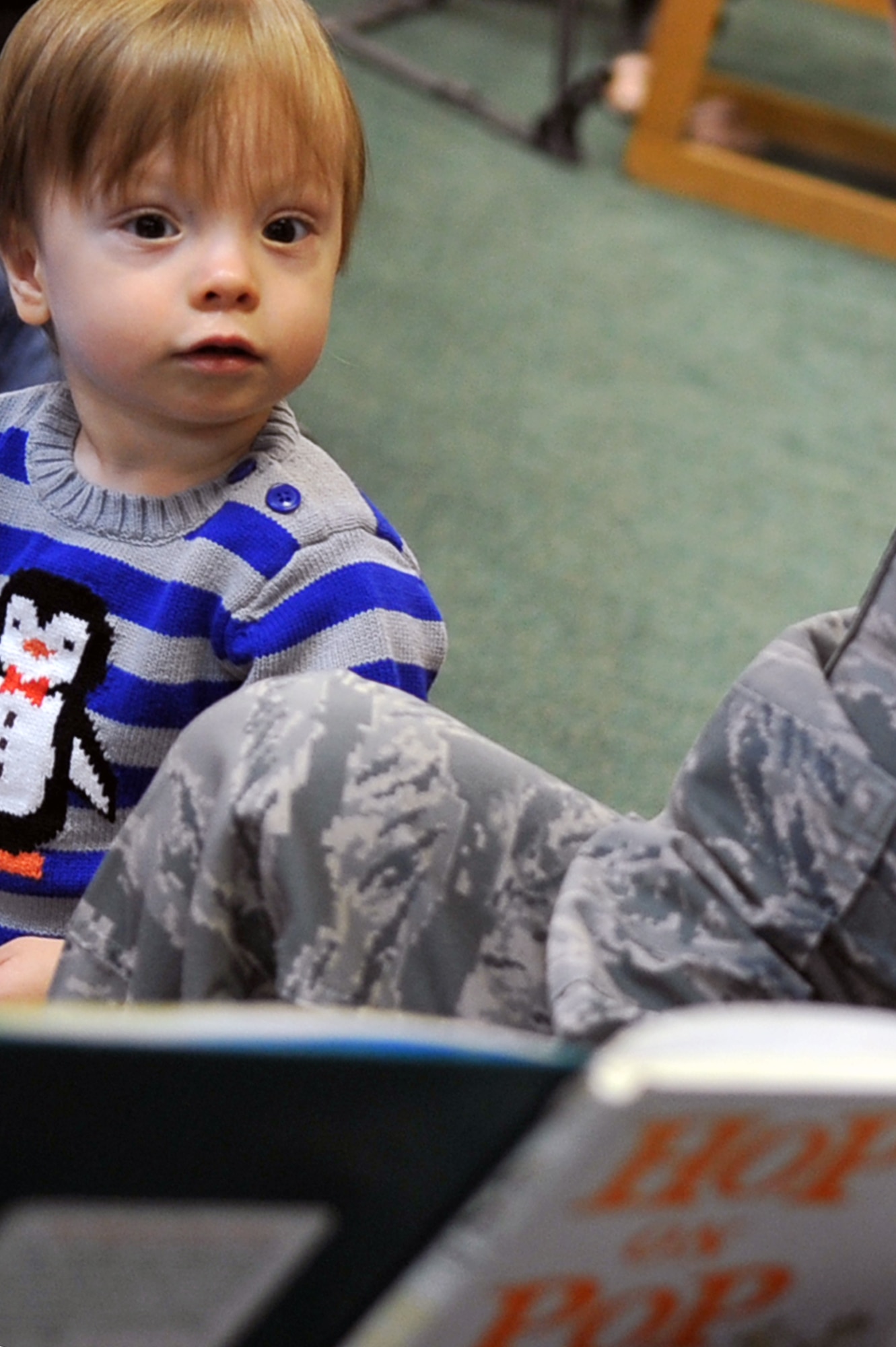 Alexander Brown, 1, watches Master Sgt. Adam Lloyd, 51st Aerospace Medicine Squadron Bioenvironmental flight chief, read Dr. Seuss’ “Hop on Pop” as part of Osan Library’s Dr. Seuss birthday celebration at Osan Air Base, Republic of Korea, Feb. 28, 2013. Dr. Seuss’ birthday, March 2, has been made National Read Across America Day to encourage children to read. Airmen at Osan volunteered to read Dr. Seuss books to a group of preschool-aged children. (U.S. Air Force photo/Airman 1st Class Alexis Siekert)