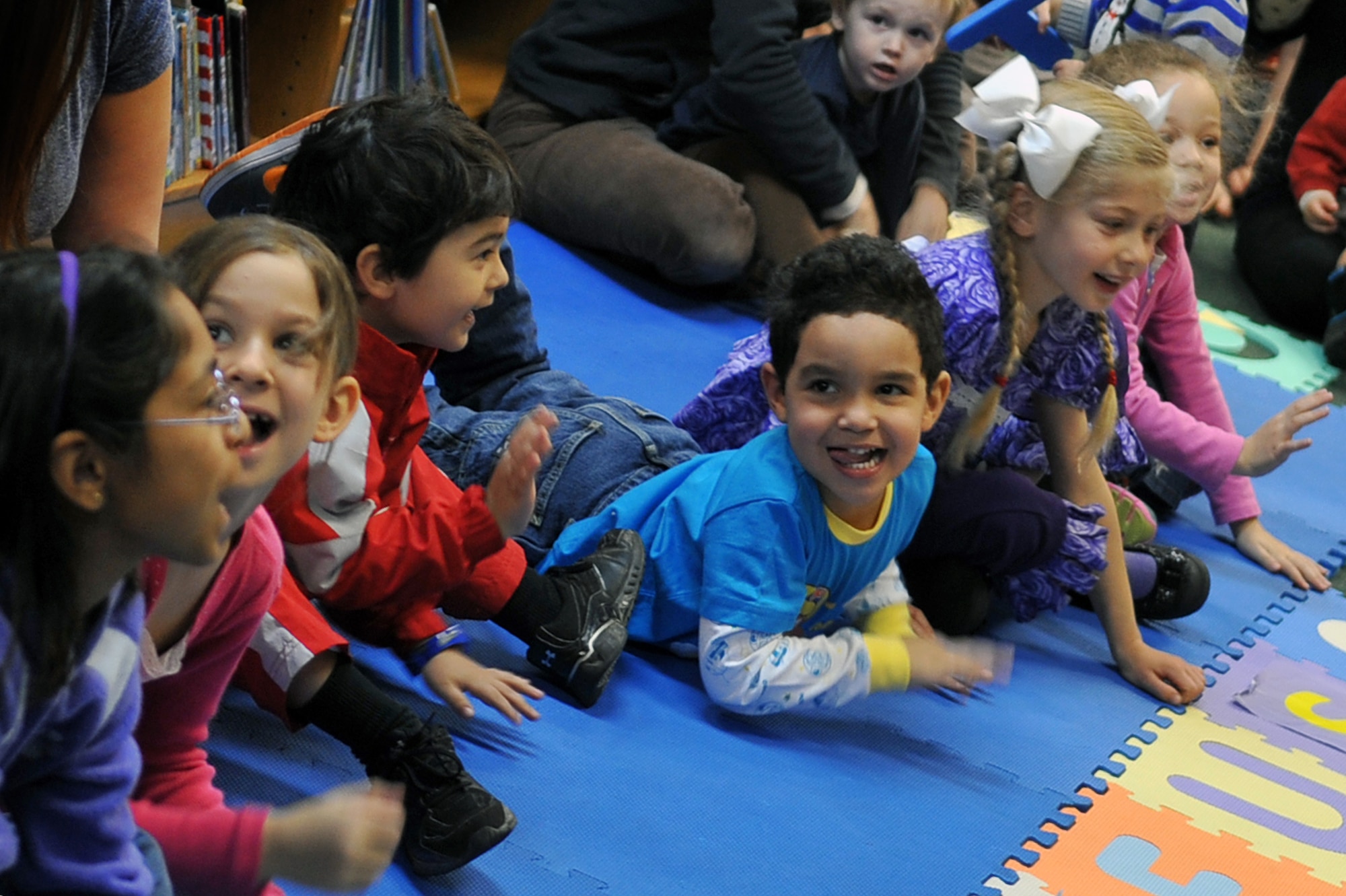 Children at the Osan Library do the Mustang Stampede for Col. Patrick McKenzie, 51st Fighter Wing commander, during the Osan Library’s Dr. Seuss birthday celebration at Osan Air Base, Republic of Korea, Feb. 28, 2013. More than 15 children came out for the celebration which included story time, crafts and a snack. (U.S. Air Force photo/Airman 1st Class Alexis Siekert)