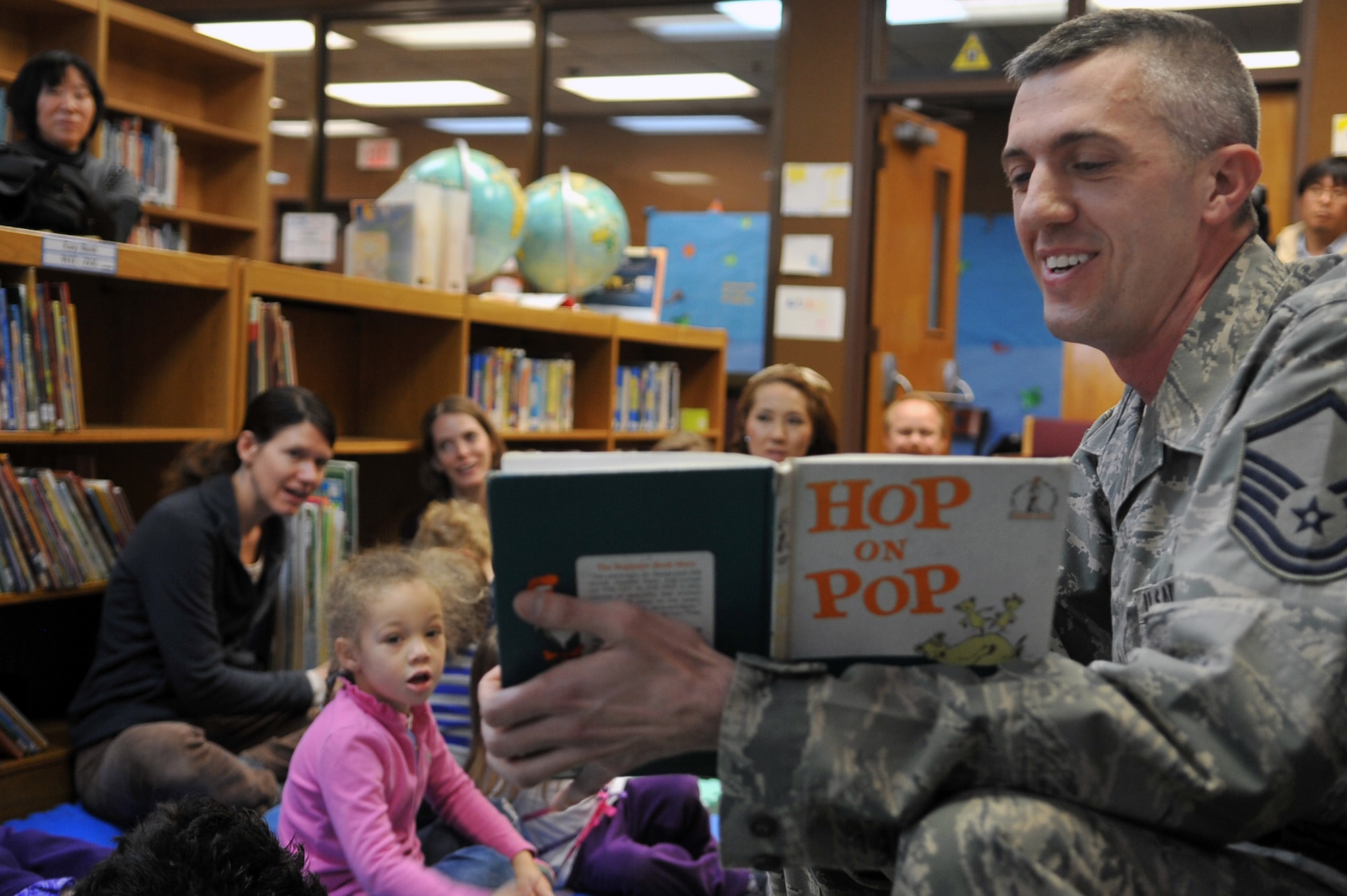 Master Sgt. Adam Lloyd, 51st Aerospace Medicine Squadron Bioenvironmental flight chief and regular volunteer at Preschool Story Time, reads “Hop on Pop” by Dr. Seuss , during the Osan Library’s Dr. Seuss birthday celebration at Osan Air Base, Republic of Korea, Feb. 28, 2013. National Read Across America Day is nation-wide celebration of reading that takes place on Dr. Seuss’ birthday, March. 2. (U.S. Air Force photo/Airman 1st Class Alexis Siekert)
