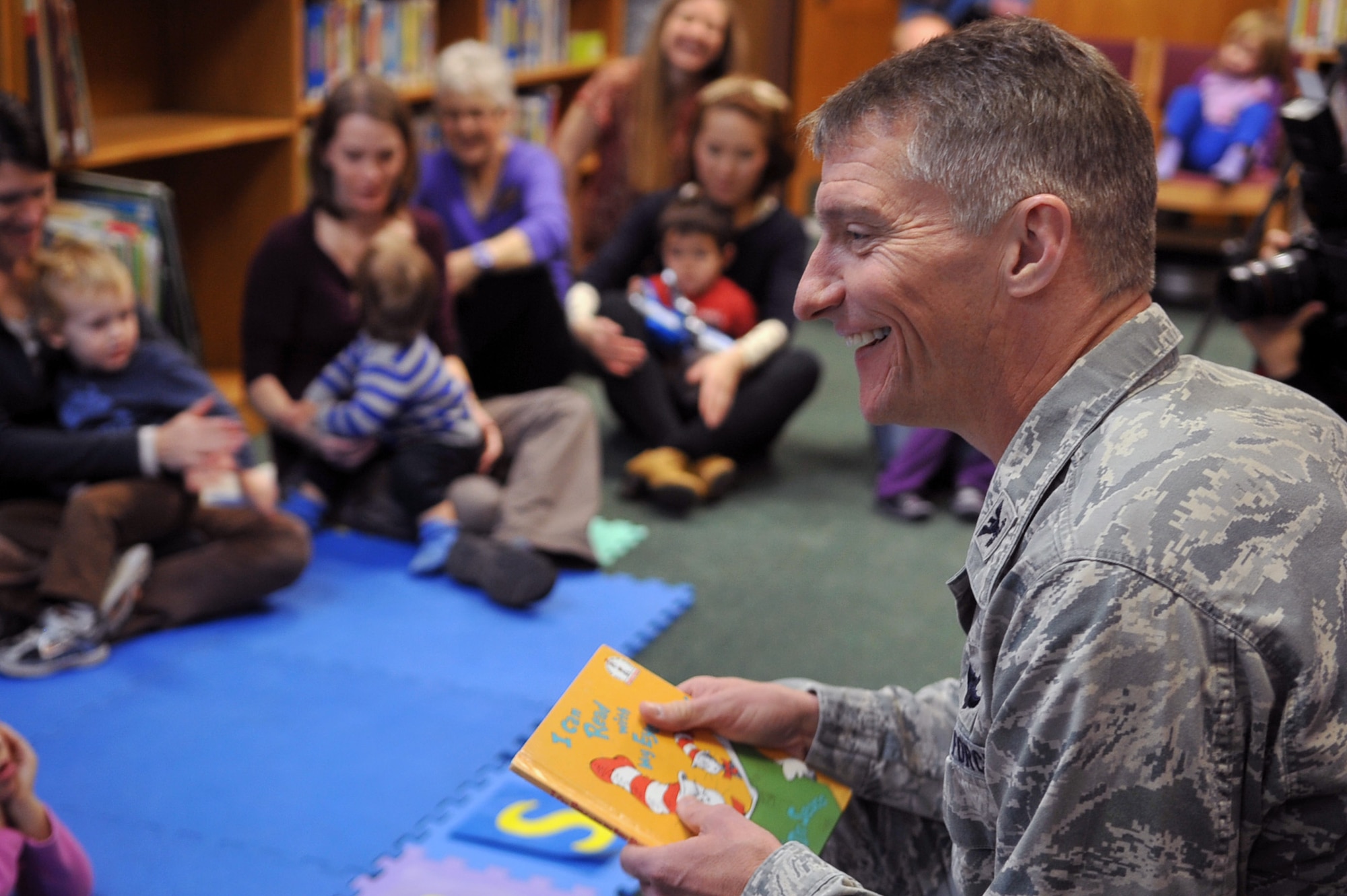 Col. Patrick McKenzie, 51st Fighter Wing commander, speaks with the children after finishing reading “I Can Read With My Eyes Shut!” by Dr. Seuss in celebration of his birthday at the Osan Library at Osan Air Base, Republic of Korea, Feb. 28, 2013. Osan Airmen volunteered to read Dr. Seuss books to a group of preschool-aged children. (U.S. Air Force photo/Airman 1st Class Alexis Siekert)