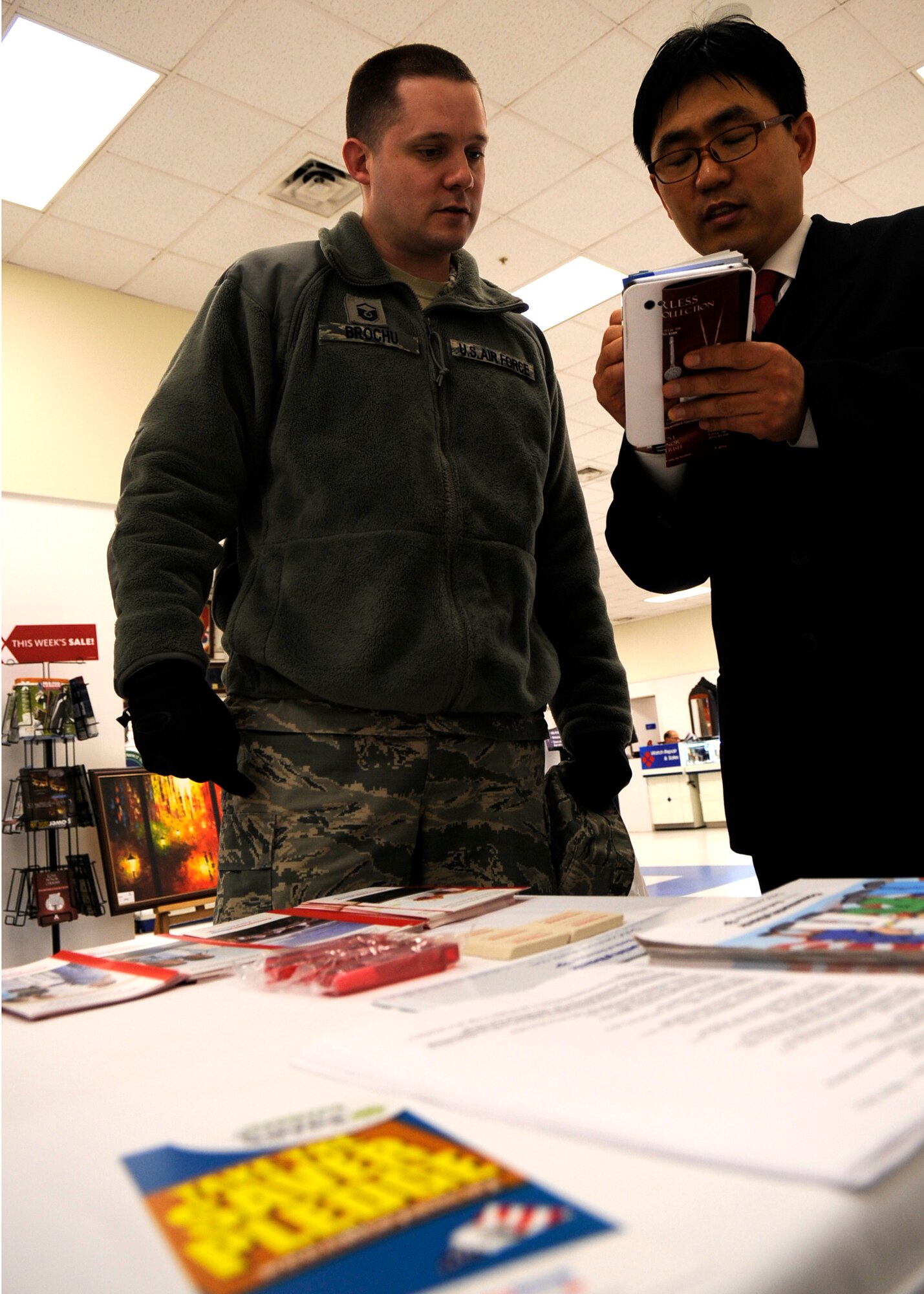 KUNSAN AIR BASE, Republic of Korea -- Master Sgt. Gilles Brochu, 8th Comptroller Squadron First Sergeant receives information about the Military Saves campaign, as Rho Kyoung Nam, Community Bank customer service specialist, talks about the program, Feb. 26, 2013 at Kunsan Air Base, Republic of Korea. The Airman and Family Readiness Center hosts many classes for Wolf Pack members to help them make and meet their financial goal. (U.S. Air Force photo by Staff Sgt. Tong Duong)