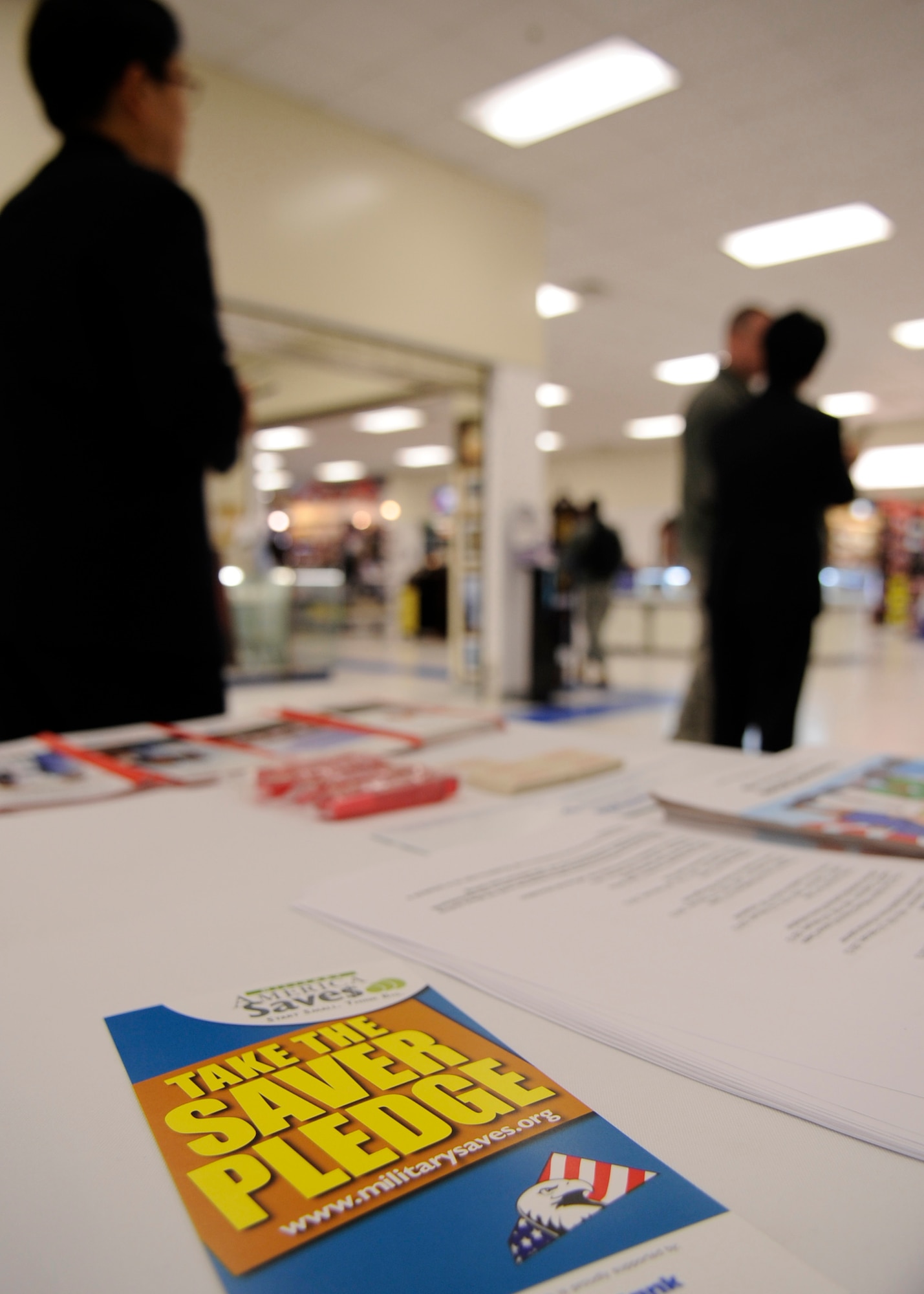 KUNSAN AIR BASE, Republic of Korea -- A customer service specialist with Community Bank speaks to Wolf Pack members regarding the Military Saves campaign Feb. 26, 2013 at Kunsan Air Base, Republic of Korea. The program is endorsed by the Department of Defense and is a weeklong event prompting service member to set financial goals and decrease their debt. (U.S. Air Force photo by Staff Sgt. Tong Duong)