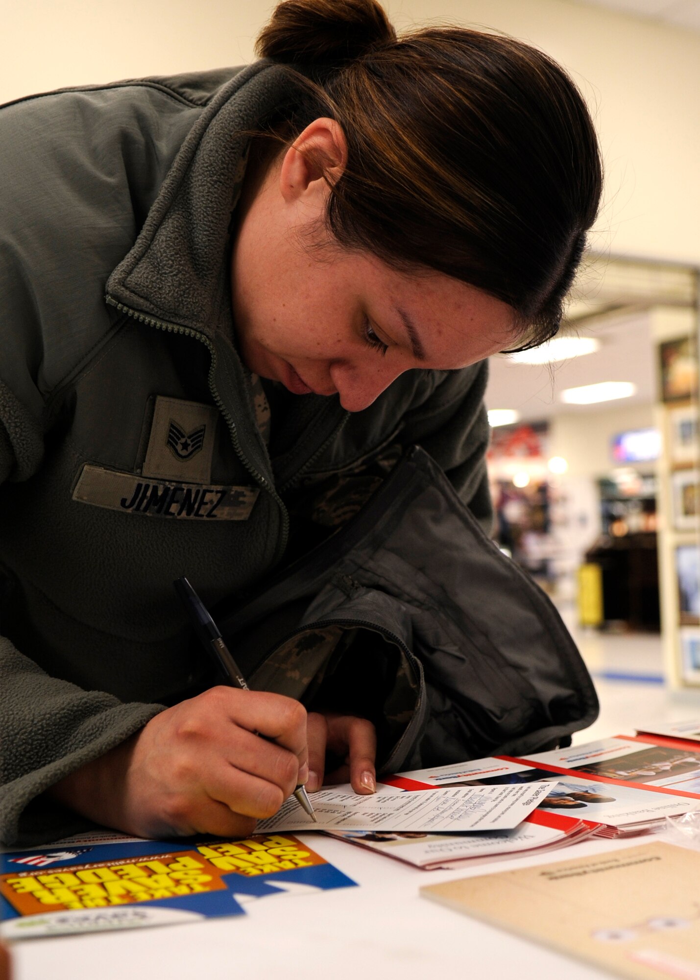 KUNSAN AIR BASE, Republic of Korea -- Staff Sgt. Margaret Jimenez, 35th Aircraft Maintenance Unit weapons load crew chief fills out a Military Saves pledge card during the weeklong campaign at the Base Exchange Feb. 26, 2013 at Kunsan Air Base, Republic of Korea. The Airman and Family Readiness Center hosts many classes for Wolf Pack members to help them make and meet their financial goals. (U.S. Air Force photo by Staff Sgt. Tong Duong)