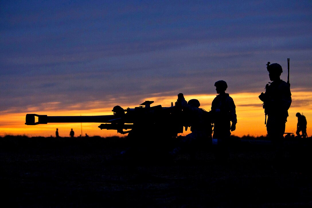 Army artillerymen prepare an M119A2 105mm howitzer for operation after parachuting it to a drop zone during a mass-tactical airborne training exercise on Fort Bragg, N.C., Feb. 25, 2013. The artillerymen are assigned to the 82nd Airborne Division’s 3rd Battalion, 319th Airborne Field Artillery Regiment, 1st Brigade Combat Team.