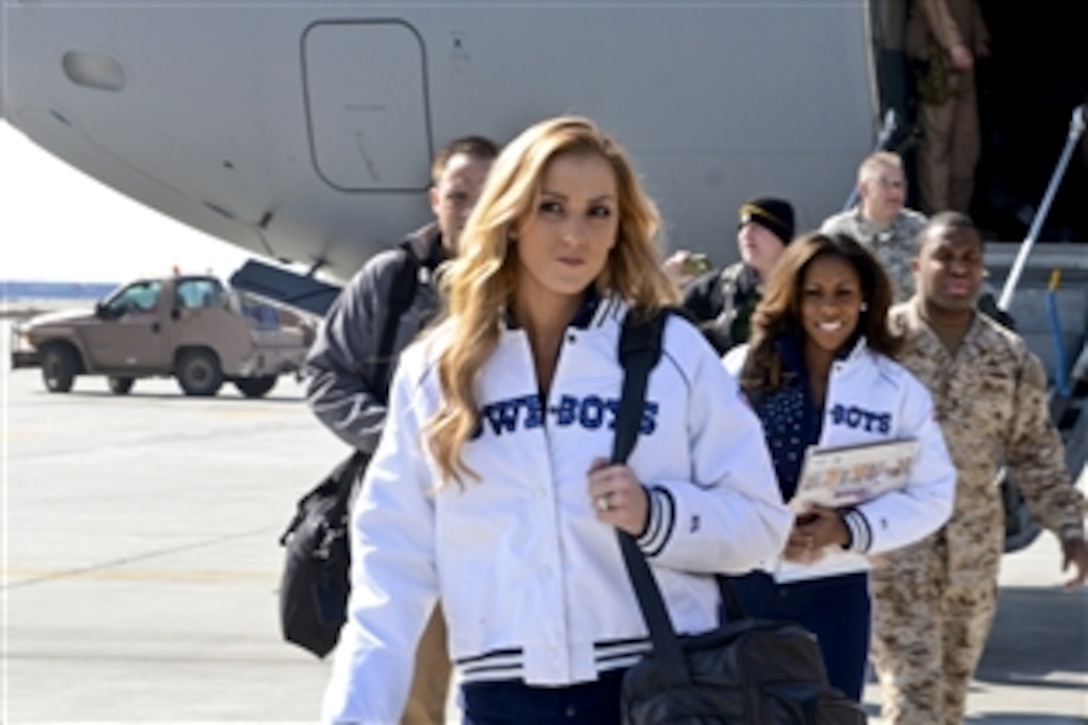Dallas Cowboys cheerleaders Cassie Trammell, front, and Jackie Bob arrive on Bagram Airfield, Afghanistan, March 3, 2013, during the USO spring tour. U.S. Navy Adm. James A. Winnefeld Jr., vice chairman of the Joint Chiefs of Staff, hosted the tour, which also includes athletes and entertainers.