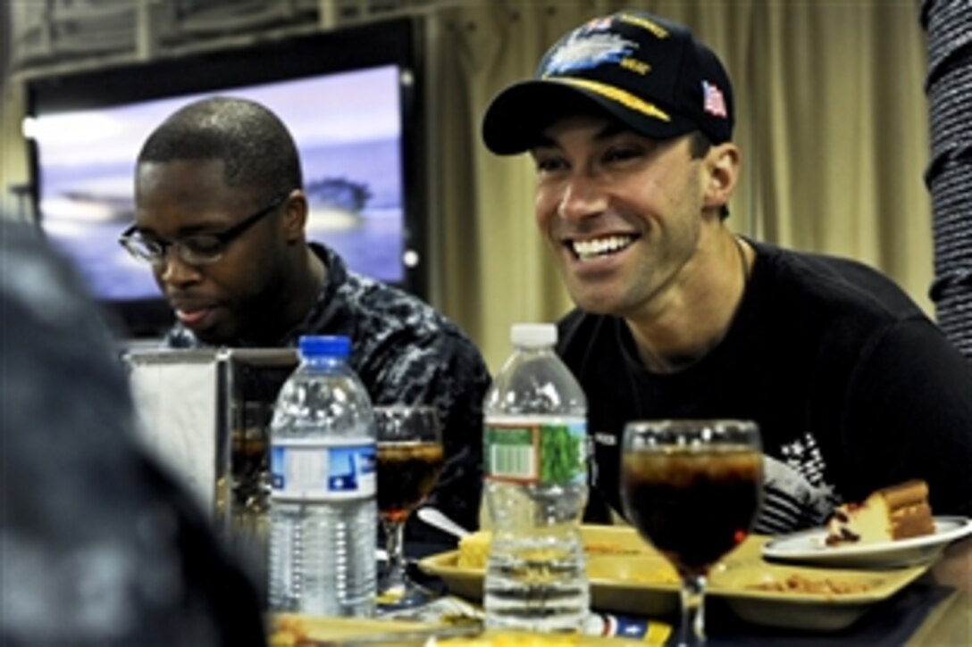 American Idol finalist Ace Young meets with U.S. sailors during the USO spring tour on the mess deck aboard the aircraft carrier USS John C. Stennis in the U.S. 5th Fleet area of responsibility, Feb. 28, 2013. The Stennis is conducting maritime security operations, theater security cooperation efforts and support missions for Operation Enduring Freedom. U.S. Navy Adm. James A. Winnefeld Jr., vice chairman of the Joint Chiefs of Staff, hosted the tour.