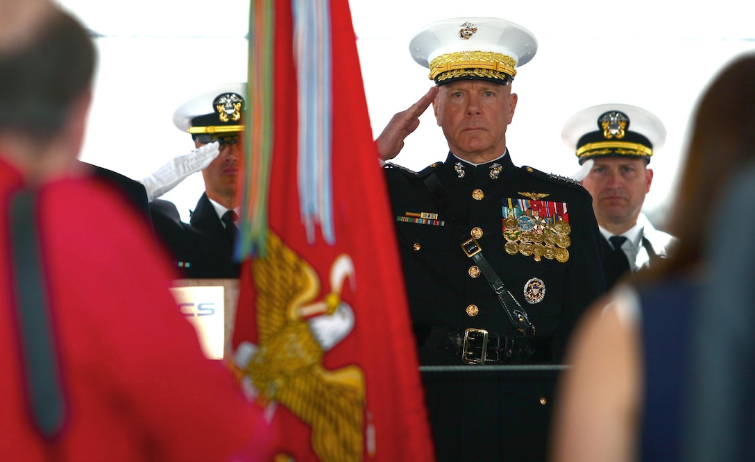 Gen. James Amos, commandant of the Marine Corps, salutes as the colors are presented before the christening ceremony for the USNS Montford Point at the General Dynamics NASSCO shipyard in San Diego, March 2. Amos spoke about the Montford Point Marines and how, like them, this mobile landing platform will be a pioneer of its own. The ship will provide a mobile pier, reducing American forces' dependency on foreign ports.