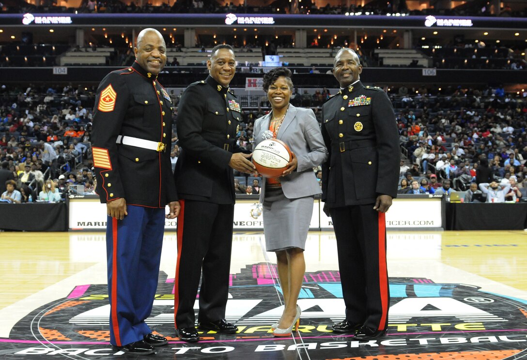 CHARLOTTE, N.C.— Sgt.Maj. Michael Logan, Brig. Gen. Craig Crenshaw, and Maj. Gen. Ronald Bailey present a signed basketball to Jacqui Carpenter, the commissioner of The Central Intercollegiate Athletic Association (CIAA),  ask a token of gratitude during the semi-finals, hosted at the Time Warner Cable Arena in Charlotte, N.C., Feb. 28, 2013. The CIAA was founded in 1912 as the Colored Intercollegiate Athletic Association, and is the oldest African-American athletic conference in the Nation. The CIAA is touted as being the third most attended basketball tournament among all NCAA divisions, and consists of Historically Black Colleges and Universities (HBCU) spanning the East Coast from Pennsylvania to North Carolina. The 2013 CIAA Tournament is expected to bring about 190,000 fans to Charlotte, N.C., during the course of the week with an economic impact exceeding $40 million. Marines from across the Nation were brought to Charlotte during the 2013 CIAA tournament to raise awareness of the Marine Corps' Officer programs to the participants and attendees of the tournament as a viable option for college graduates after they transition from college to professional life.