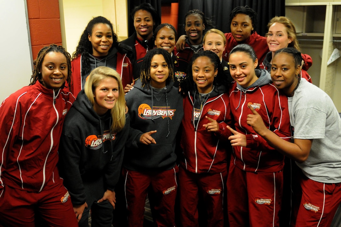 CHARLOTTE, N.C.— GySgt Tawanda Hanible and Capt. Martha MacPhee pose with players of the Shaw University Women’s Basketball Team, moments after giving a motivational pre-game locker room speech during the finals of The Central Intercollegiate Athletic Association (CIAA),  hosted at the Time Warner Cable Arena in Charlotte, N.C., March 02, 2013. The CIAA was founded in 1912 as the Colored Intercollegiate Athletic Association, and is the oldest African-American athletic conference in the Nation. The CIAA is touted as being the third most attended basketball tournament among all NCAA divisions, and consists of Historically Black Colleges and Universities (HBCU) spanning the East Coast from Pennsylvania to North Carolina. The 2013 CIAA Tournament is expected to bring about 190,000 fans to Charlotte, N.C., during the course of the week with an economic impact exceeding $40 million. Marines from across the Nation were brought to Charlotte during the 2013 CIAA tournament to raise awareness of the Marine Corps' Officer programs to the participants and attendees of the tournament as a viable option for college graduates after they transition from college to professional life.