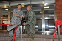 U.S. Air Force Col. Gary Schneider, 18th Civil Engineer Group commander, and U.S. Marine Corps Col. Michael Kuhn, Camp Courtney commander, cut a ribbon for the opening of Tower 4506 on Camp Courtney, Japan, Feb. 21, 2013. The 718th Civil Engineer Squadron manages military family housing on island and is also initiates and oversees all renovations. The ribbon cutting was an open house event for accompanied military personnel E1-E6 to tour the housing unit. (U.S. Air Force photo/Airman 1st Class Keith James)