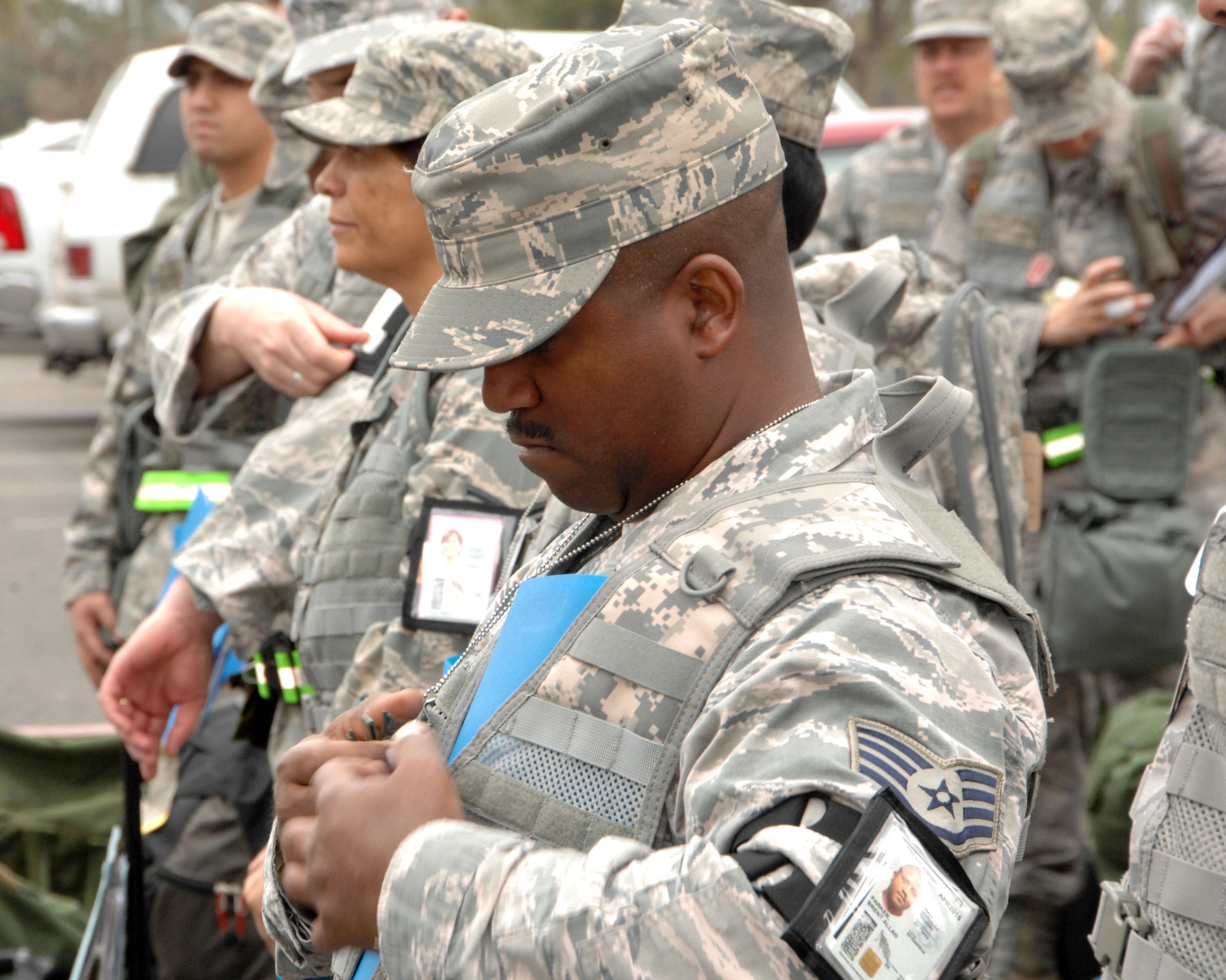 Staff Sgt. Brent Parker pulls his dog tags out for inspection during a prepare the force exercise for the upcoming ORI (Operational Readiness Inspection) at the 146th Airlift Wing, Port Hueneme, Calif. March 3, 2013. (U.S. Air Force photo by: Senior Airman Nicholas Carzis.)