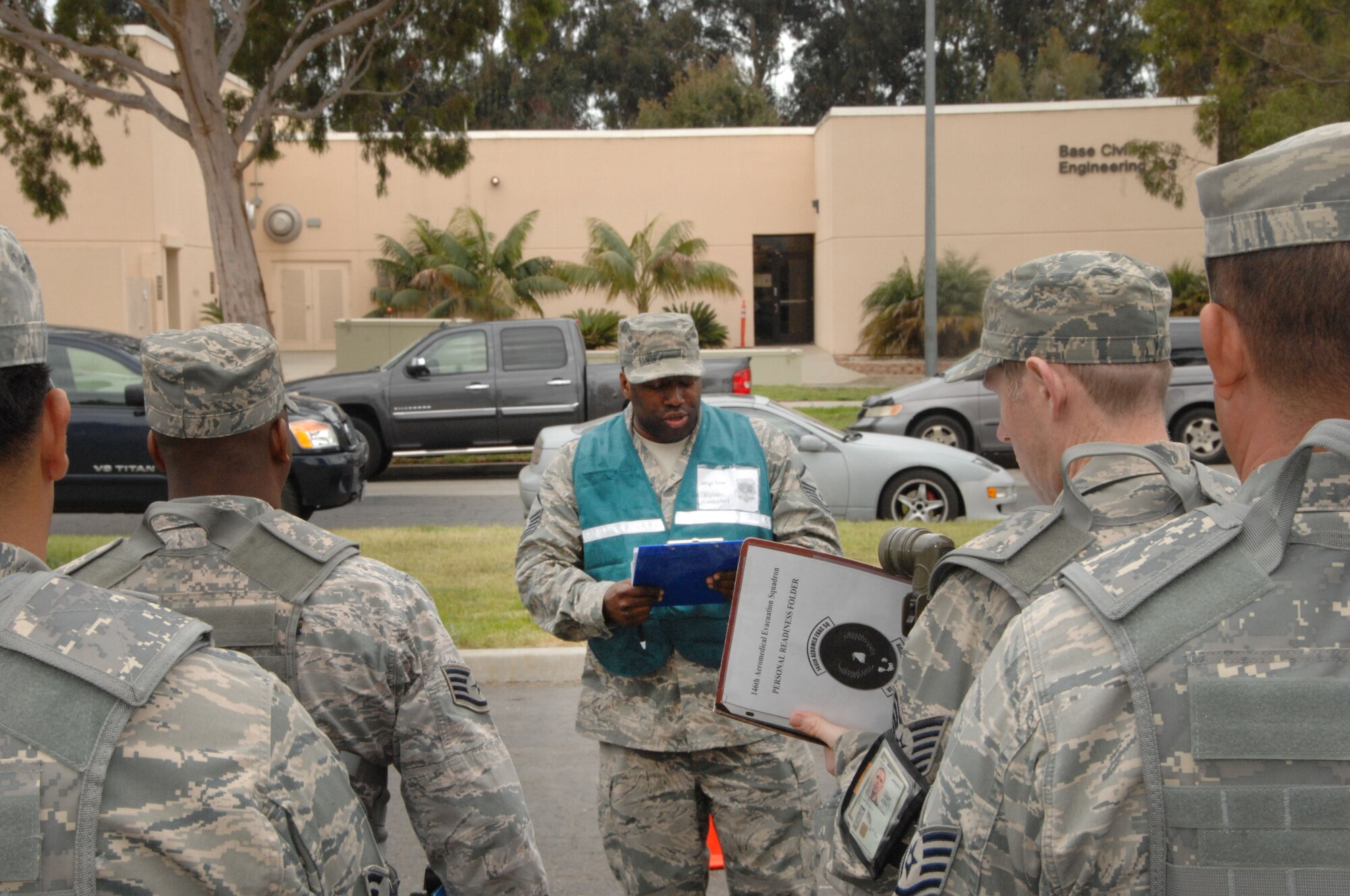 Master Sgt. Jeromee Tate briefs a team of combined Airmen known as Chalk 6 during a prepare the force exercise for an upcoming ORI (Operational Readiness Inspection) at the 146th Airlift Wing located in Port Hueneme, Calif. March 3, 2012. (U.S. Air Force photo by: Senior Airman Nicholas Carzis)