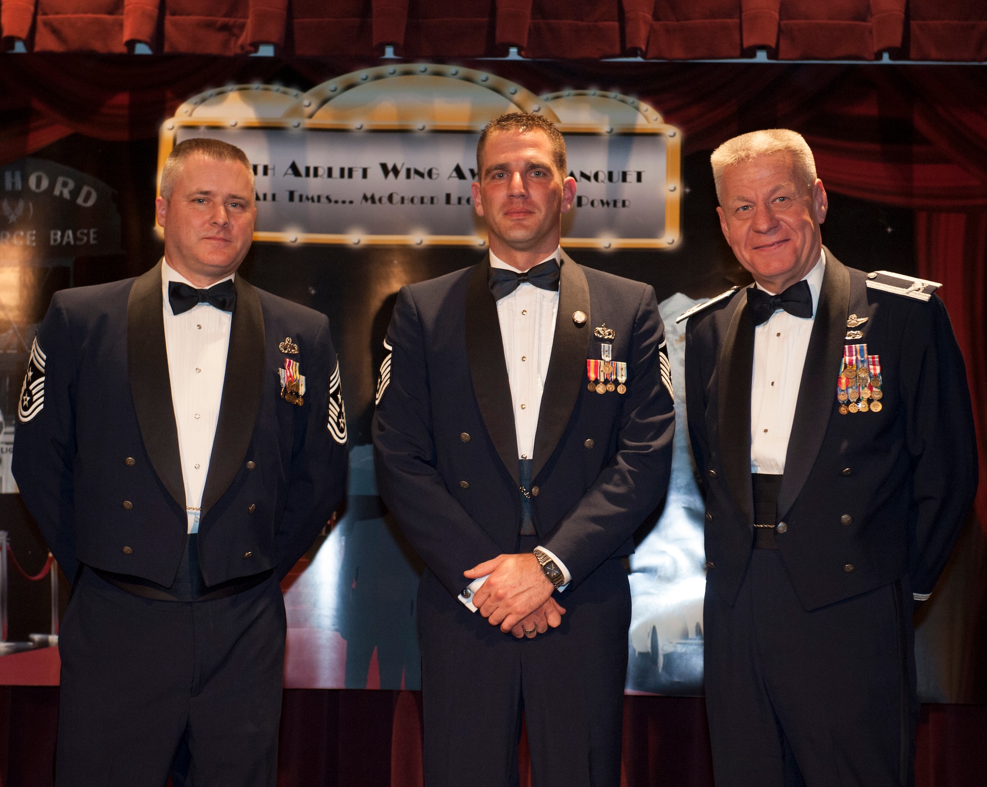 Master Sgt. Chris Brown, a 446th Airlift Wing recruiter, is recognized as the Top Air Force Reserve Command Line Recruiter, Top Non-Prior Service Recruiter and winner of the Commander Emphasis Award with Col. Bruce Bowers, 446th AW Commander, and Chief Master Sgt. Tony Mack, 446th AW Command Chief, during the 446th's Annual Awards Banquet at the McChord Colocated Club here March 2. Brown's hard work garnered the AFRC 90 new accessions with 54 non prior service applicants. (U.S. Air Force Photo/ Master Sgt. Eli Yamzon)