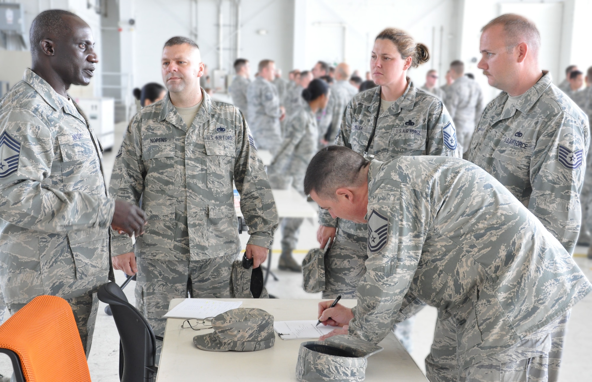 Chief Master Sgt. Stephen Nnodim, 583rd RED HORSE Squadron's chief enlisted manager, talks with members of the 13th Reconnassiance Squadron about vacancies within the new Reserve unit on Beale Air Force Base, Calif. The 940th Wing held an internal career fair during March Unit Training Assembly to match available positions with 13 RS members looking for new careers due to their squadron's upcoming deactivation. (U.S. Air Force photo/Senior Airman Adam Hamar)