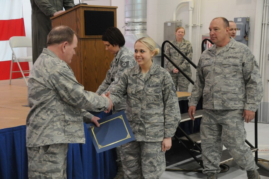 Tech. Sgt. Melissa Knight, with the 185th Air Refueling Wing (ARW), receives a certificate of appreciation from Col. Brian Miller, 185th Base Commander, for serving overseas.  Members of the 185th ARW were honored in a welcome home ceremony for deploying overseas, at the 185th base in, Sioux City, Iowa, March 3, 2013. (U.S. Air Force Photo by tech. Sgt. Oscar Sanchez / Released)