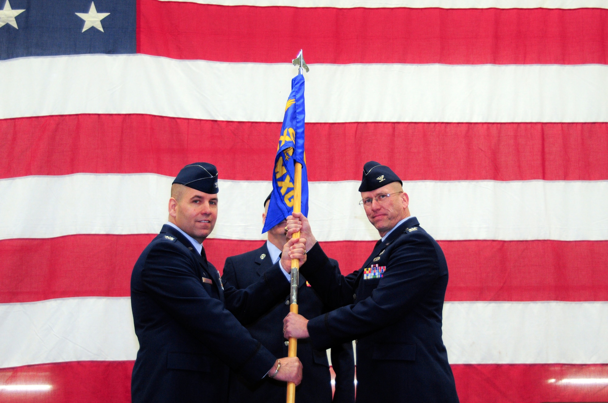 YOUNGSTOWN AIR RESERVE STATION, Ohio -- U.S. Air Force Reserve Col. James Dignan presents Col. David Post with the 910th Maintenance Group guidon during an assumption of command ceremony March 2, 2013 here. Post began his tenure as group commander immediately following the ceremony. U.S. Air Force photo by Senior Airman Ron Dombkowski