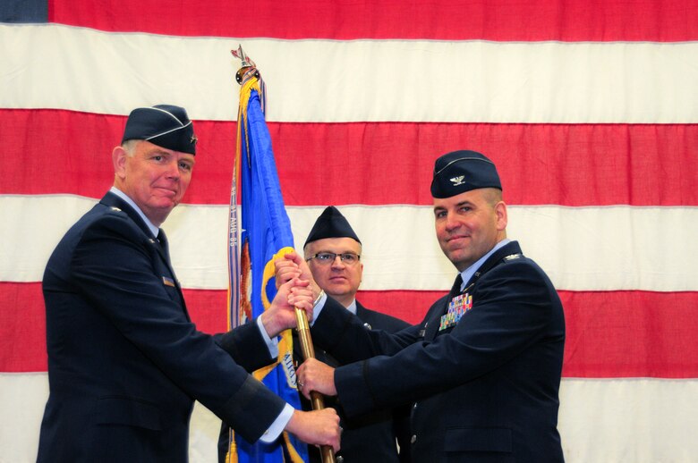 YOUNGSTOWN AIR RESERVE STATION, Ohio – U.S. Air Force Reserve Maj. Gen. Wallace W. Farris Jr., commander of 22nd Air Force, presents Col. James Dignan with the 910th Airlift Wing guidon during a change of command ceremony March 2, 2013 here. Dignan assumed command of the 910th Airlift Wing from interim wing commander, U.S. Air Force Brig. Gen. Brian Dominguez. U.S. Air Force photo by Senior Airman Ron Dombkowski