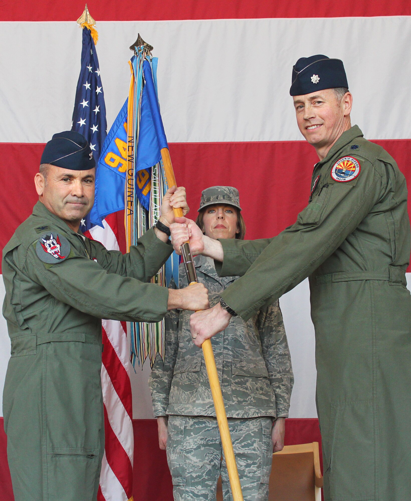 Lt. Col. Gerry Brown accepts command of the 69th Fighter Squadron from Col. Kurt Gallegos, commander, 944th Fighter Wing, at a change-of-command ceremony here March 1. (U.S. Air Force Photo By Tech. Sgt. Meredith Mingledorff) 