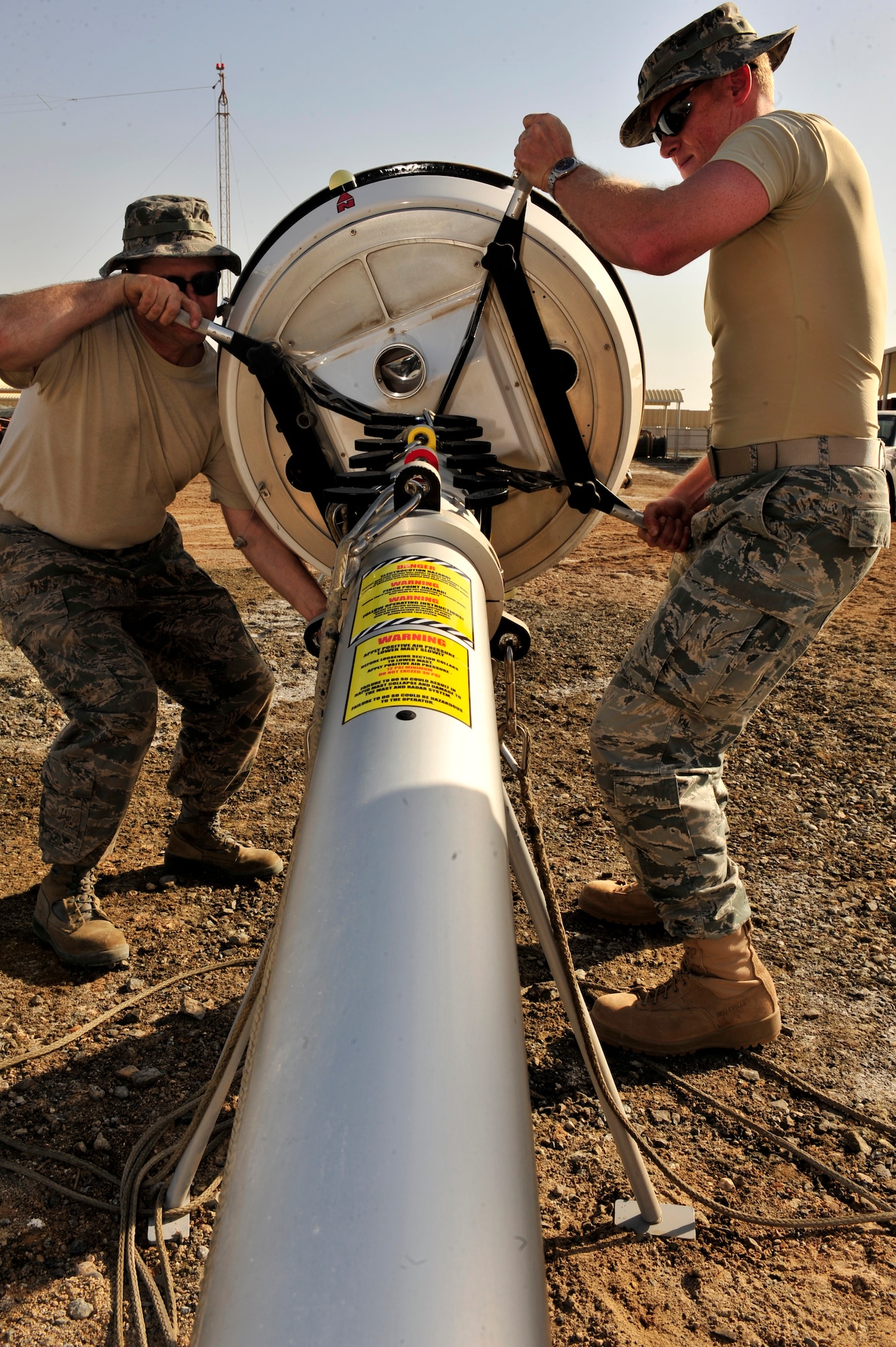 U.S. Air Force Capt. Brian DeCicco, 380th Operations Support Squadron weather flight commander, deployed from Beale Air Force Base, Calif., and Senior Master Sgt. Ronald Bradford, 380th OSS weather flight NCO in charge, deployed from McGuire AFB, N.J., re-attaches the E700XD X Band Doppler Weather Radar to its stand during a monthly preventative maintenance inspection at an undisclosed location in Southwest Asia Feb. 21, 2013. The radar, in use for three months, provides updates every five minutes which allow additional lead time to prepare pilots for possible inclement weather. (U.S. Air Force photo by Tech. Sgt. Christina M. Styer/Released) 