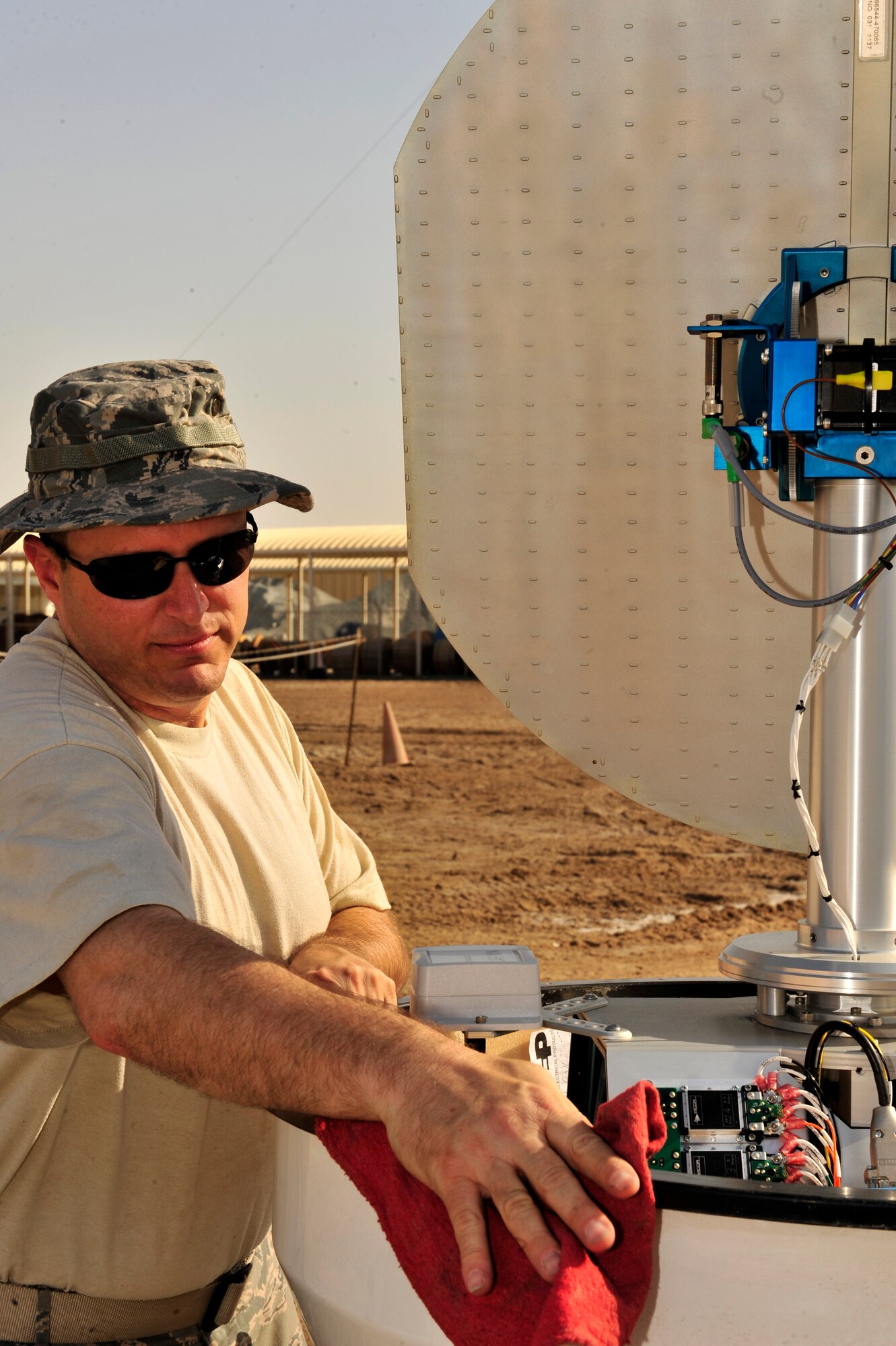 U.S. Air Force Senior Master Sgt. Ronald Bradford, 380th OSS weather flight NCO in charge, deployed from McGuire AFB, N.J., thoroughly cleans the E700XD X Band Doppler Weather Radar stand during a monthly preventative maintenance inspection at an undisclosed location in Southwest Asia Feb. 21, 2013. PMIs are conducted daily to check the pressure in the stand that keeps the radar elevated. (U.S. Air Force photo by Tech. Sgt. Christina M. Styer/Released) 