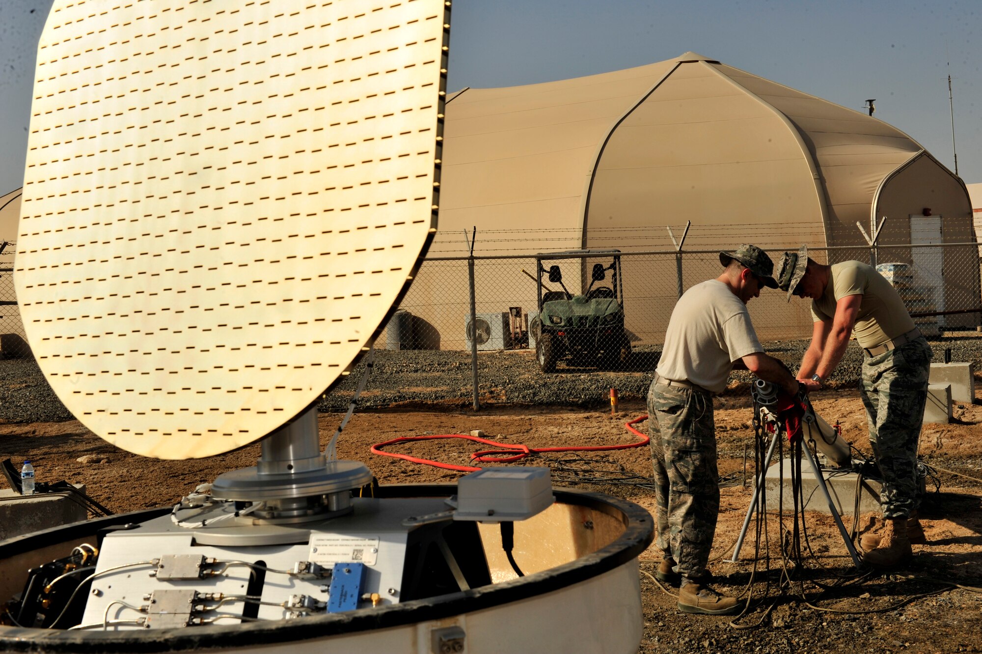 U.S. Air Force Capt. Brian DeCicco, 380th Operations Support Squadron weather flight commander, deployed from Beale Air Force Base, Calif., and Senior Master Sgt. Ronald Bradford, 380th OSS weather flight NCO in charge, deployed from McGuire AFB, N.J., thoroughly clean the E700XD X Band Doppler Weather Radar stand during a monthly preventative maintenance inspection at an undisclosed location in Southwest Asia Feb. 21, 2013. Every 20 seconds the Doppler Radar rotates, performs one full scan at 16 different degree levels, tilting up a little higher each time which provides three-dimensional scans every five minutes. (U.S. Air Force photo by Tech. Sgt. Christina M. Styer/Released) 