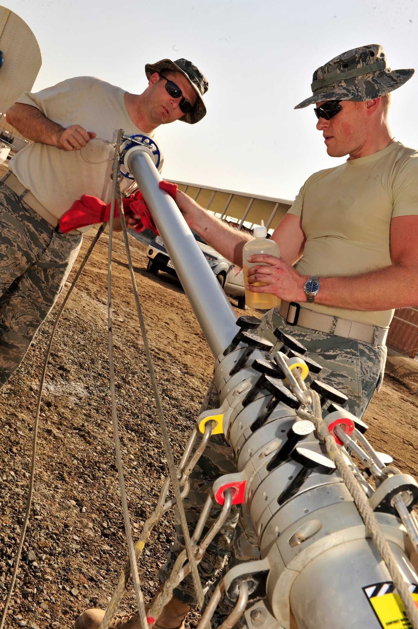 U.S. Air Force Capt. Brian DeCicco, 380th Operations Support Squadron weather flight commander, deployed from Beale Air Force Base, Calif., and Senior Master Sgt. Ronald Bradford, 380th OSS weather flight NCO in charge, deployed from McGuire AFB, N.J., thoroughly clean the E700XD X Band Doppler Weather Radar stand during a monthly preventative maintenance inspection at an undisclosed location in Southwest Asia Feb. 21, 2013. The radar, in use for three months, provides updates every five minutes which allow additional lead time to prepare pilots for possible inclement weather. (U.S. Air Force photo by Tech. Sgt. Christina M. Styer/Released) 
