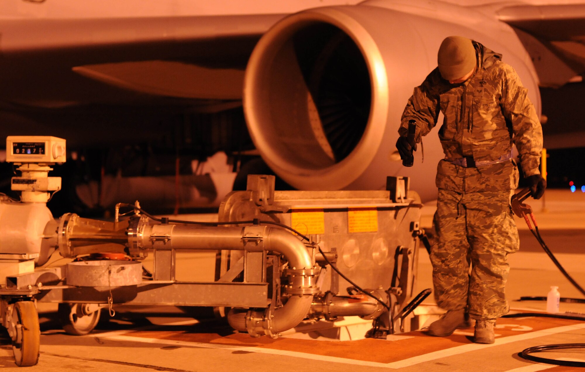 Senior Airman Dillon Moore, 100th Logistics Readiness Squadron fuels technician, inspects an in-ground fuel pump while fueling a KC-135 Stratotanker Feb. 28, 2013. Moore, from Reno, Nev., is deployed to southwest Europe in support of French operations in Mali. KC-135 aircrews from the 100th Air Refueling Wing, RAF Mildenhall, England, have been flying aerial refueling sorties from the deployed location since January. (U.S. Air Force photo/Staff Sgt. Austin M. May)