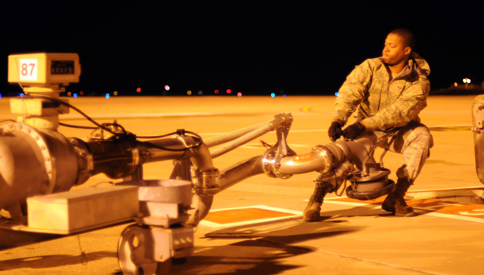 Senior Airman Jason Wells, 52nd Logistics Readiness Squadron, deployed from Spangdhalem Air Base, Germany, moves a pantograph fuel pipe into position in preparation for refueling a KC-135 Stratotanker Feb. 28, 2013. Wells, a fuels technician from Pahokee, Fla., is deployed to southwest Europe in support of French operations in Mali. KC-135 aircrews from the 100th Air Refueling Wing, RAF Mildenhall, England, have been flying aerial refueling sorties from the deployed location since January. (U.S. Air Force photo/Staff Sgt. Austin M. May)