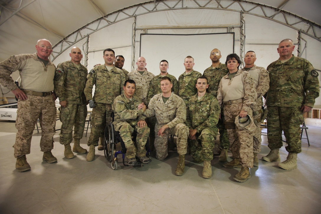 Regional Command Southwest Commanding General, Maj. Gen. W. Lee Miller Jr., RC (SW) Sergeant Major, Sgt. Maj. Paul A. Berry, and RC (SW) Command Master Chief, CMDCM Kelly McNulty stand with the wounded warriors of Operation Proper Exit aboard Camp Leatherneck, March 2.