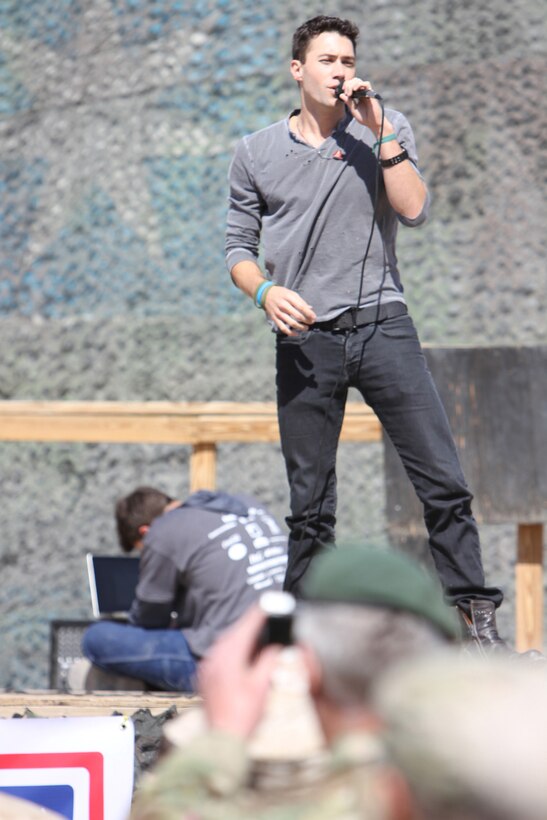 American Idol's season five finalist Ace Young sings to troops here, March 1, during the USO Spring Troop Visit. Celebrities visiting included Dallas Cowboys cheerleaders, four-time National Football League Most Valuable Player and Denver Broncos quarterback Peyton Manning, Tampa Bay Buccaneers receiver Vincent Jackson, retired Major League Baseball pitcher and three-time World Series winner Curt Schilling, Indianapolis Colts receiver Austin Collie, quarterbacks coach Clyde Christensen, and American Idol's season three runner-up Diana Degarmo and season five finalist Ace Young. The weeklong tour included stops to various military installations such as Walter Reed National Military Medical Center in Bethesda, Md., Joint Base Andrews, Md., Camp Lemonnier, Djibouti, Naval Air Station Rota, Spain, Naval Air Station Sigonella, Italy, and other locations.