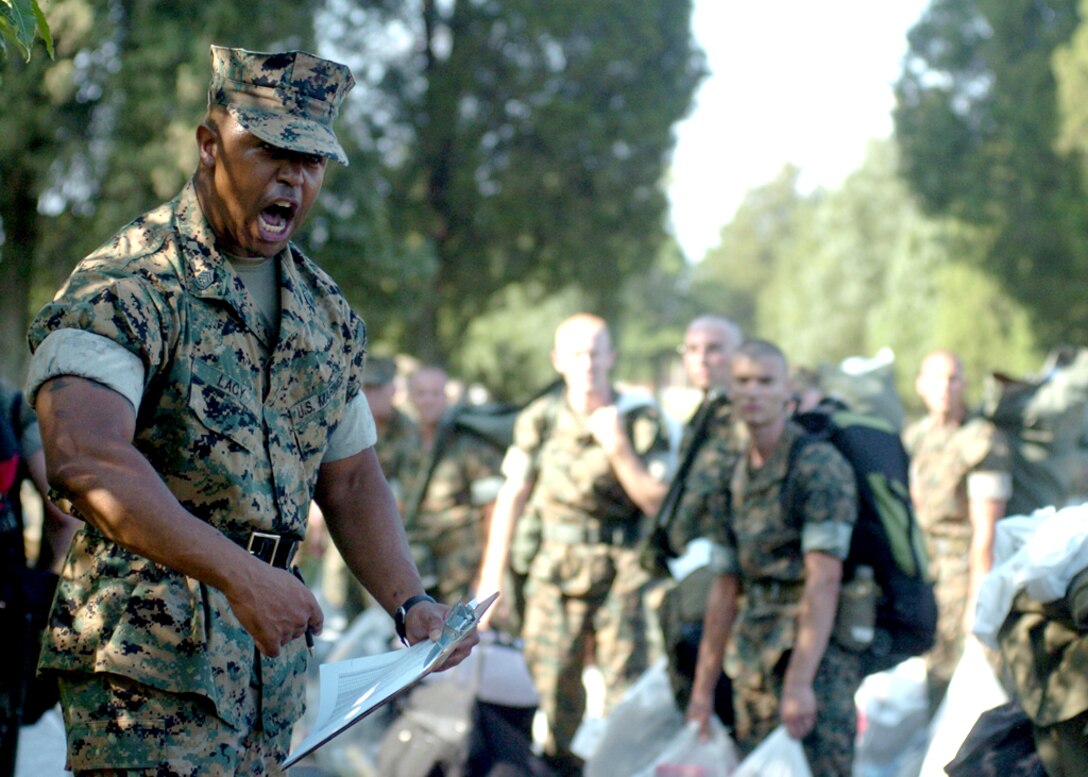 Candidates from Charlie company race about on the parade deck to get themselves situated in platoon formation for pickup with their Sergeant Instructors June 6, 2007. These candidates, upon pickup, will be subject to a contraband search, all of which that are found (such as cell phones, walkmans, etc.) will be confiscated and returned at the end of the training cycle.
