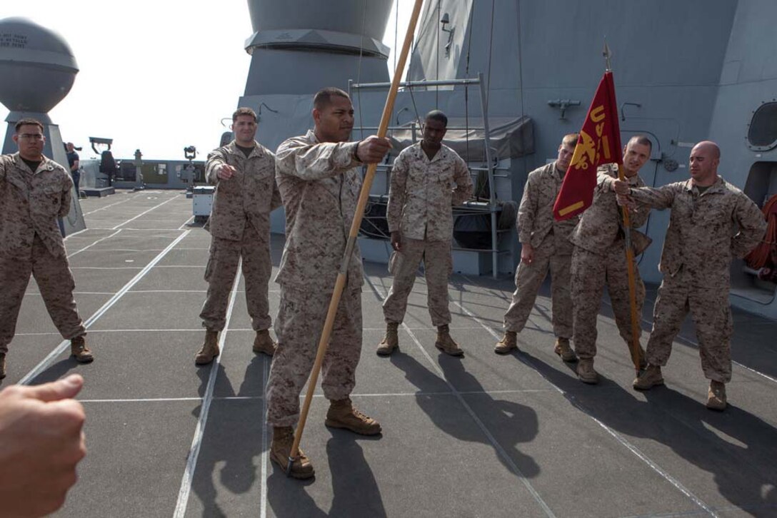 Marines with the 15th Marine Expeditionary Unit learn how to properly handle a guidon during Corporals' Course aboard the USS Green Bay, Feb. 26. Corporals' Course is professional military education for enlisted Marines designed to give them the tools to become effective small unit leaders. The 15th MEU is deployed as part of the Peleliu Amphibious Ready Group as a U.S. Central Command theater reserve force, providing support for maritime security operations and theater security cooperation efforts in the U.S. 5th Fleet area of responsibility. (U.S. Marine Corps photo by Cpl. Bobby J. Gonzalez/Released)