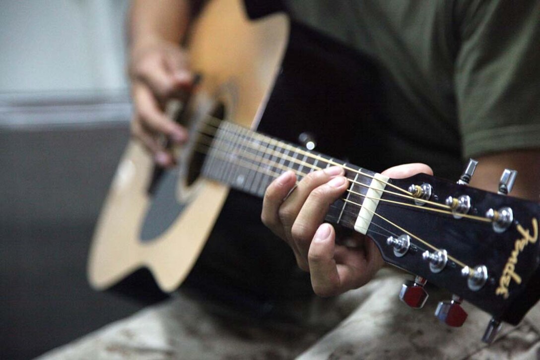 Corporal Bernard Vu, field radio operator, 2nd Platoon, Battery B, Battalion Landing Team 3/5, 15th Marine Expeditionary Unit, practices playing guitar aboard the USS Rushmore, Feb. 27. While away, servicemembers find many ways to pass time while improving themselves and others physically, mentally and professionally. The 15th MEU is deployed as part of the Peleliu Amphibious Ready Group as a U.S. Central Command theater reserve force, providing support for maritime security operations and theater security cooperation efforts in the U.S. 5th Fleet area of responsibility. Vu, 20, is from Lincoln, Neb. (U.S. Marine Corps photo by Cpl. Timothy R. Childers/ Released)